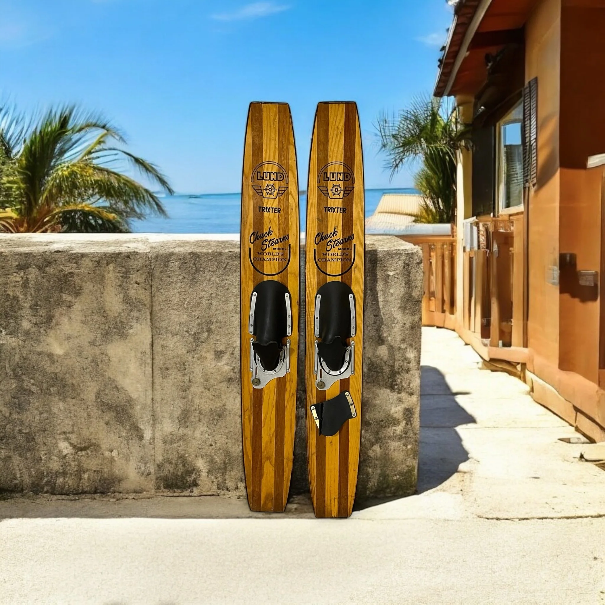 Pair of vintage 1960s Lund wooden water skis, Chuck Stearns Trixter model, perfect lake house decor or for nautical themed rooms.