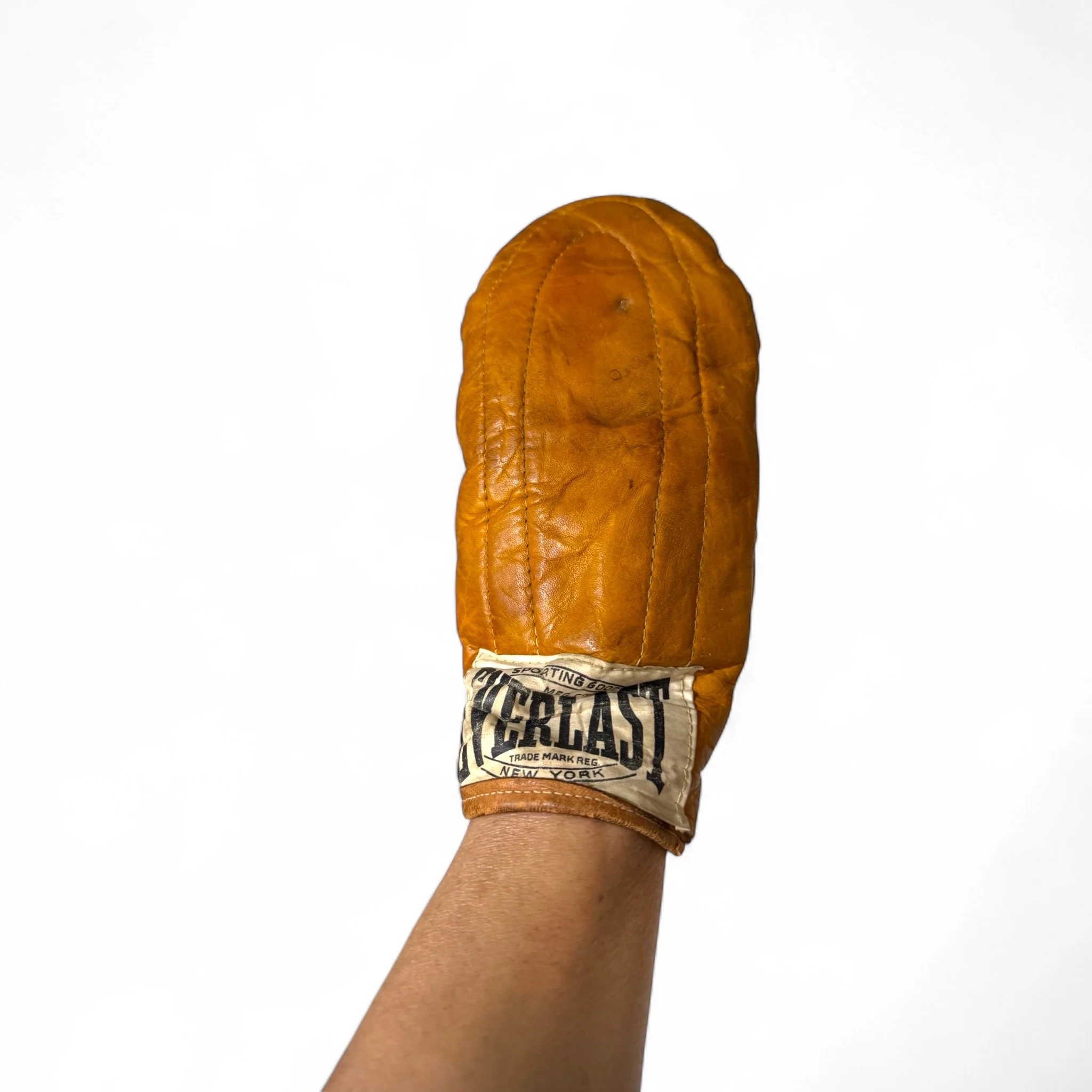 Pair of vintage Everlast leather speed boxing gloves in orange brown color with Everlast Sporting Goods logo prominently displayed on the front, retro training gear and collectible boxing decor.