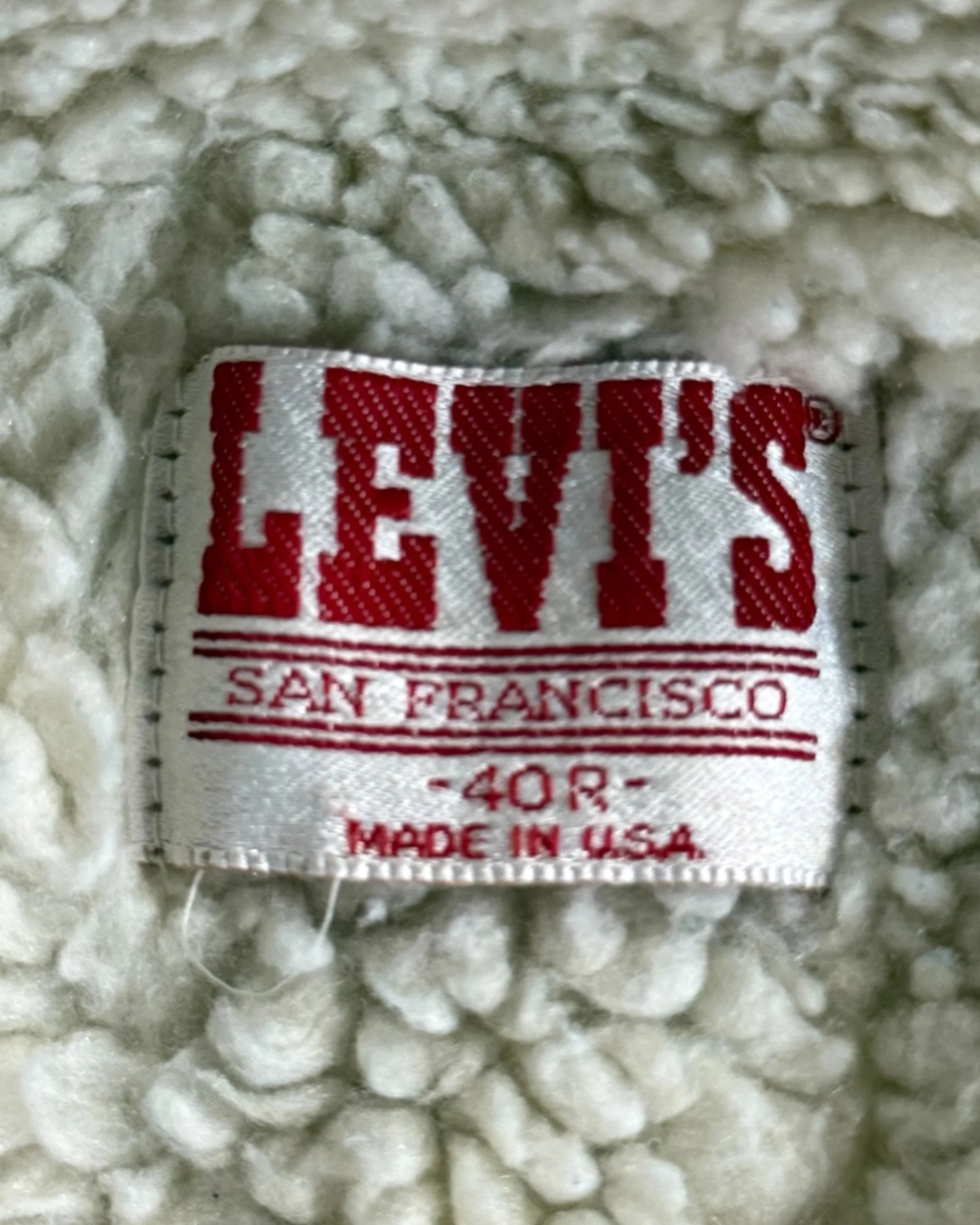 vintage label on 1980s Levi's sherpa lined denim trucker jacket