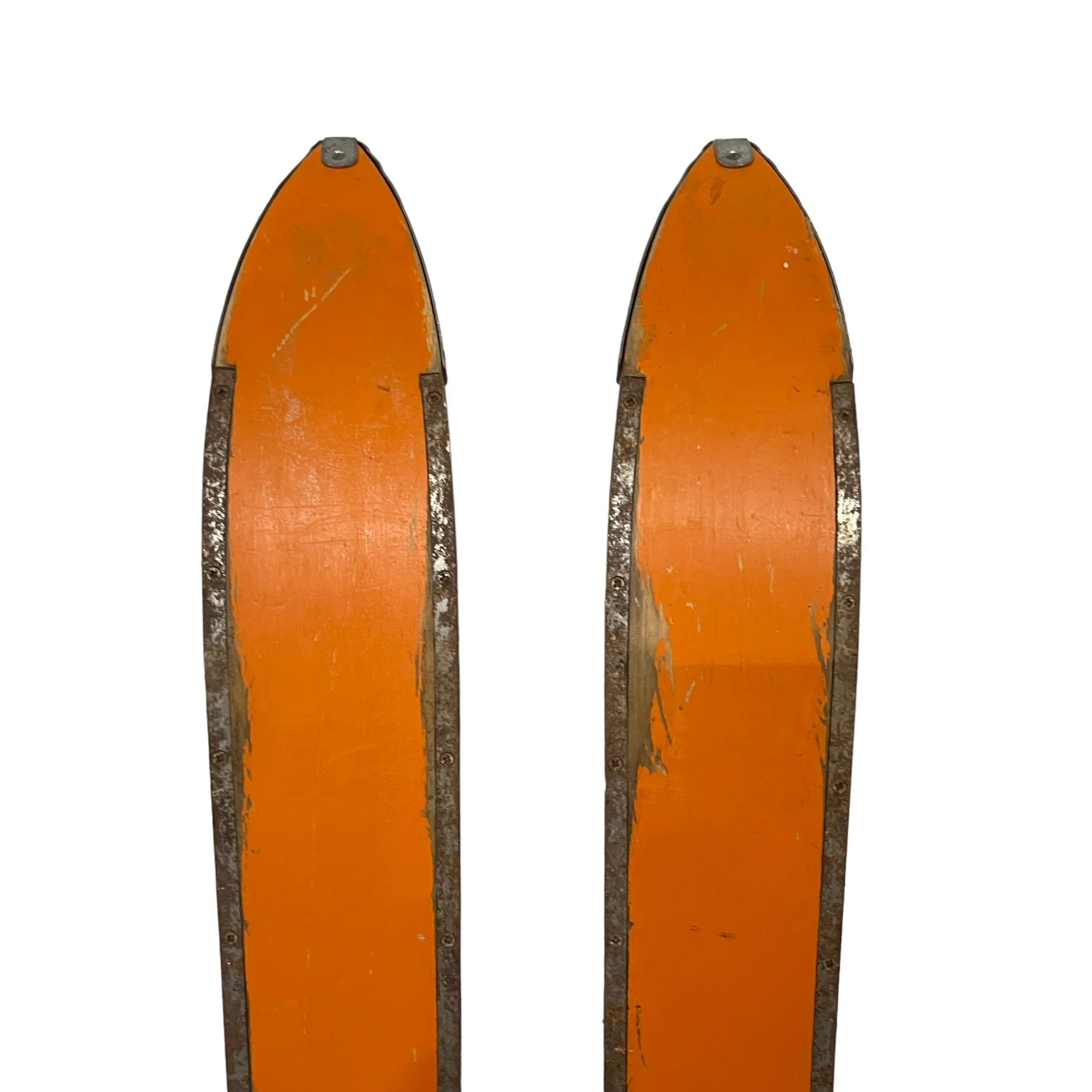 Close up back view of the tips of a pair of kids vintage snow skis.
