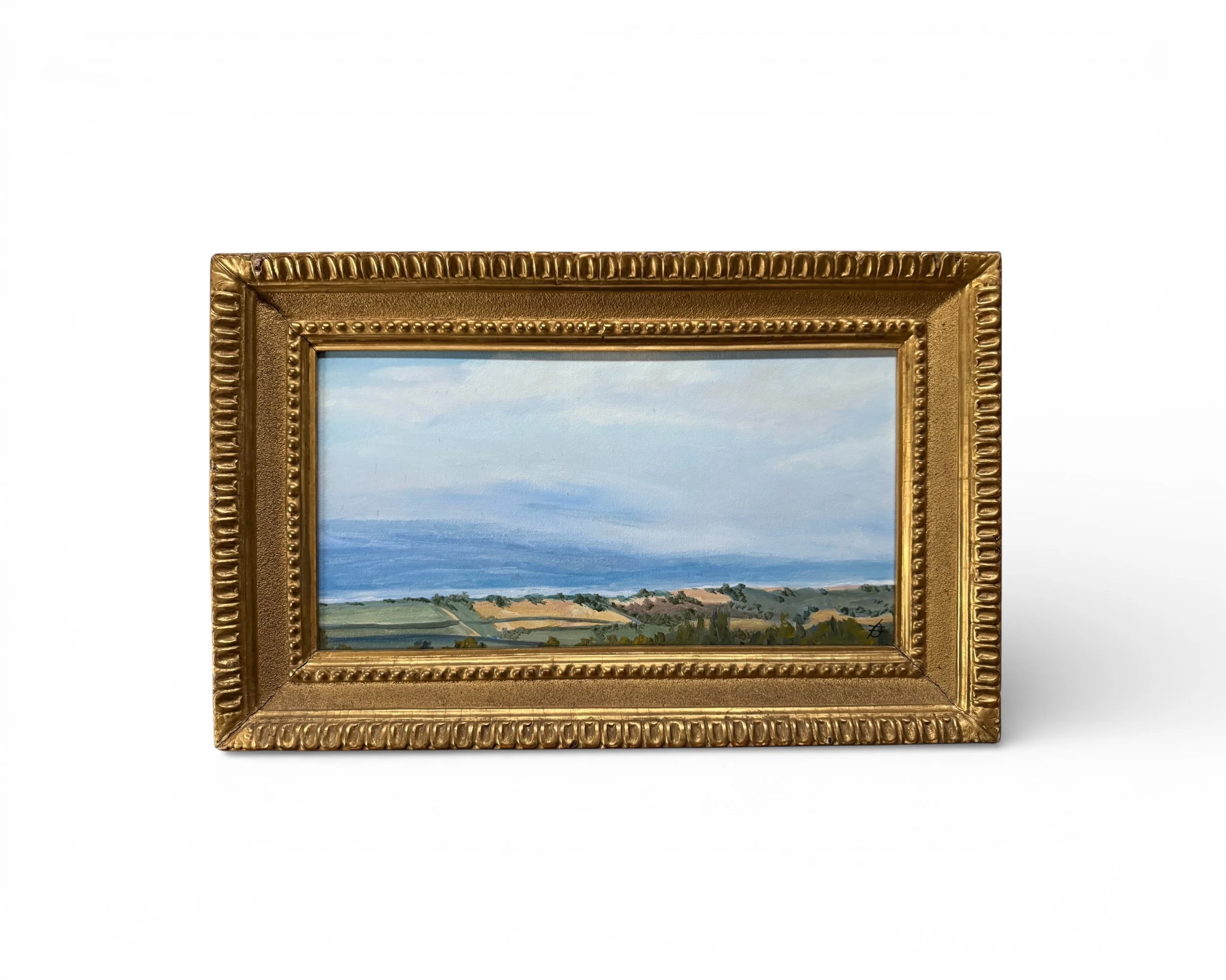 Vintage original landscape painting in gilded frame featuring water and cloudy blue skies