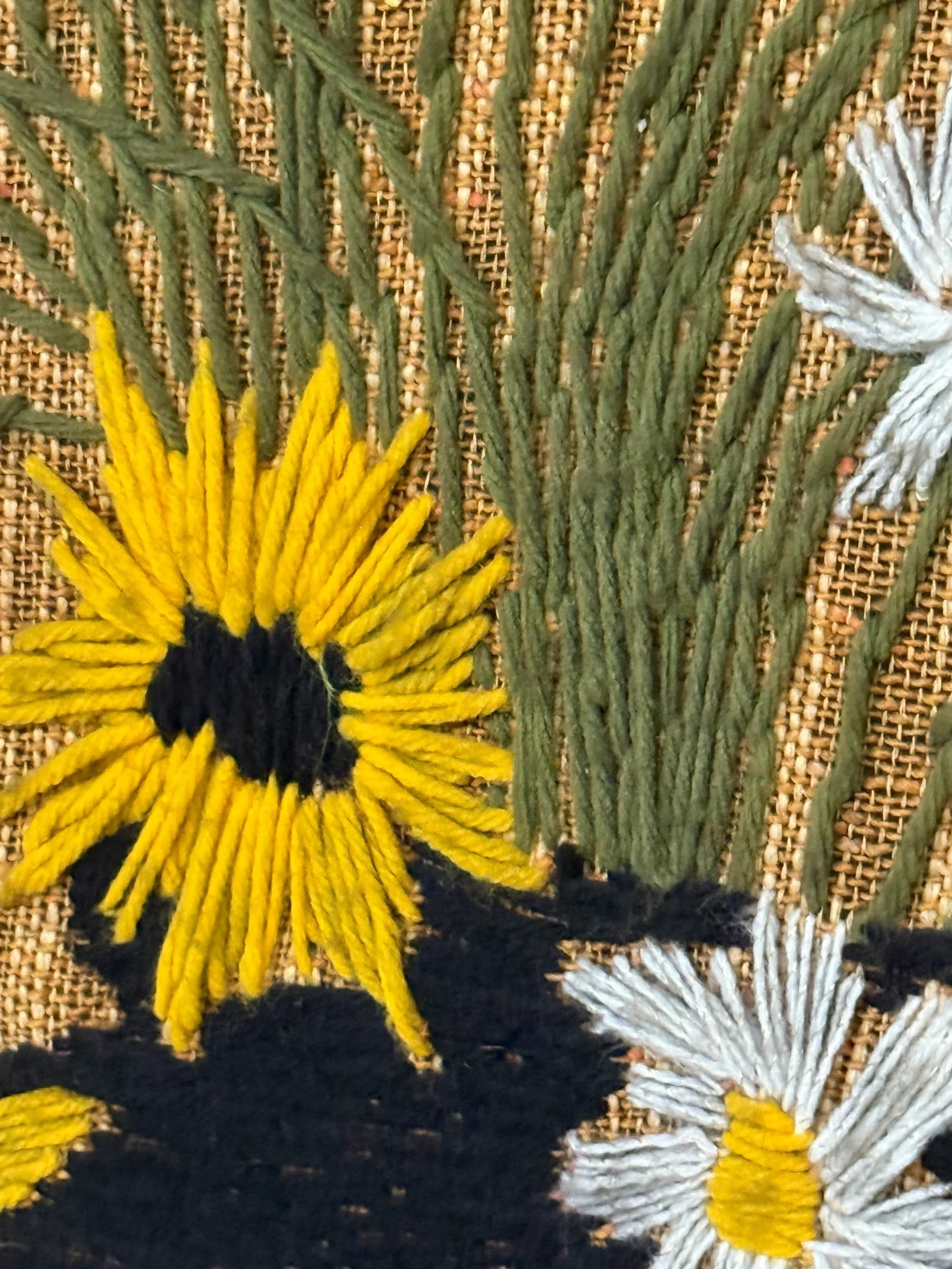 Extra large vintage 1970s crewel embroidery wall hanging featuring colorful potted daisies in detailed needlework, textile tapestry home decor.