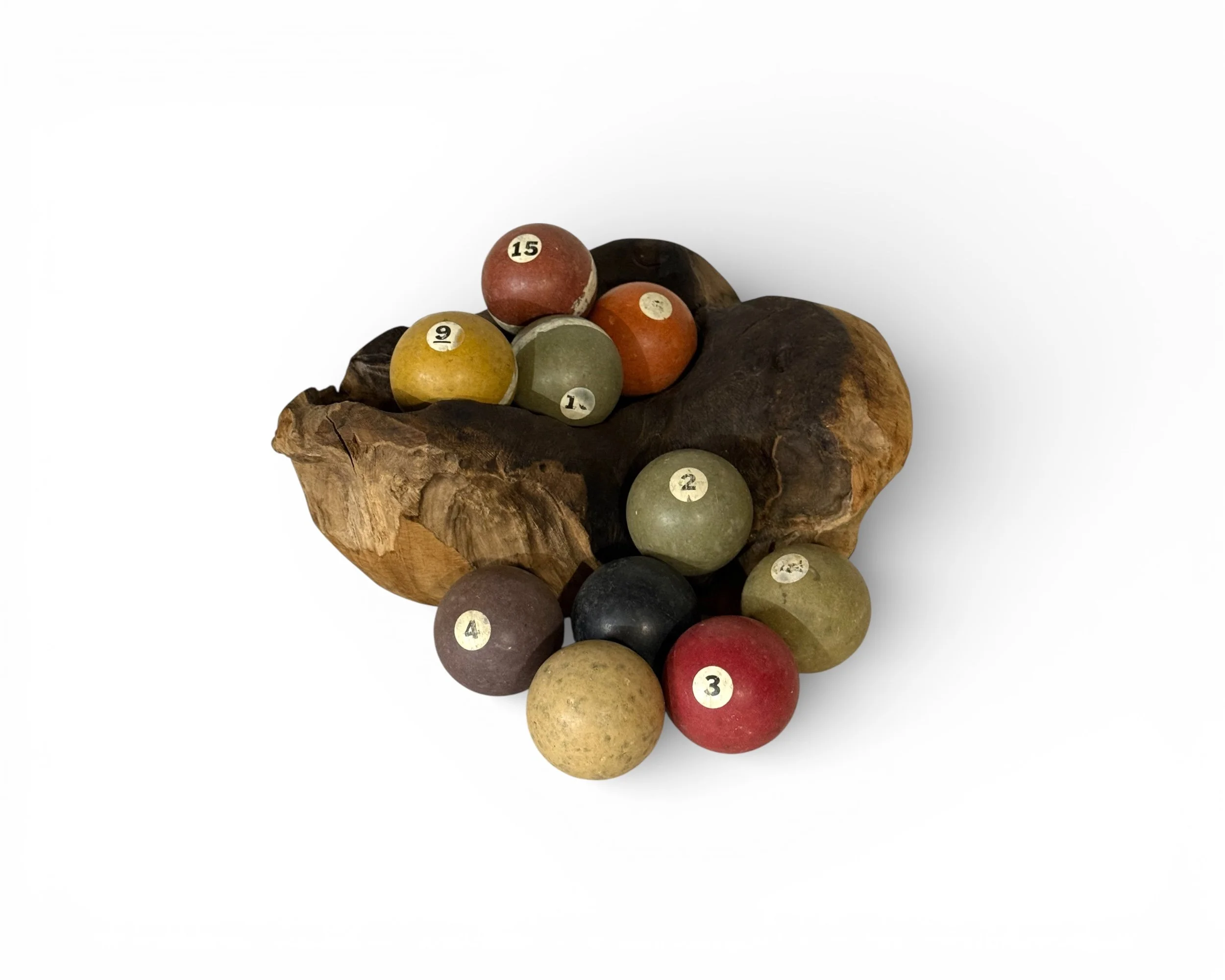 set of vintage clay billiard balls shown in a sculptural wooden bowl for decorative display