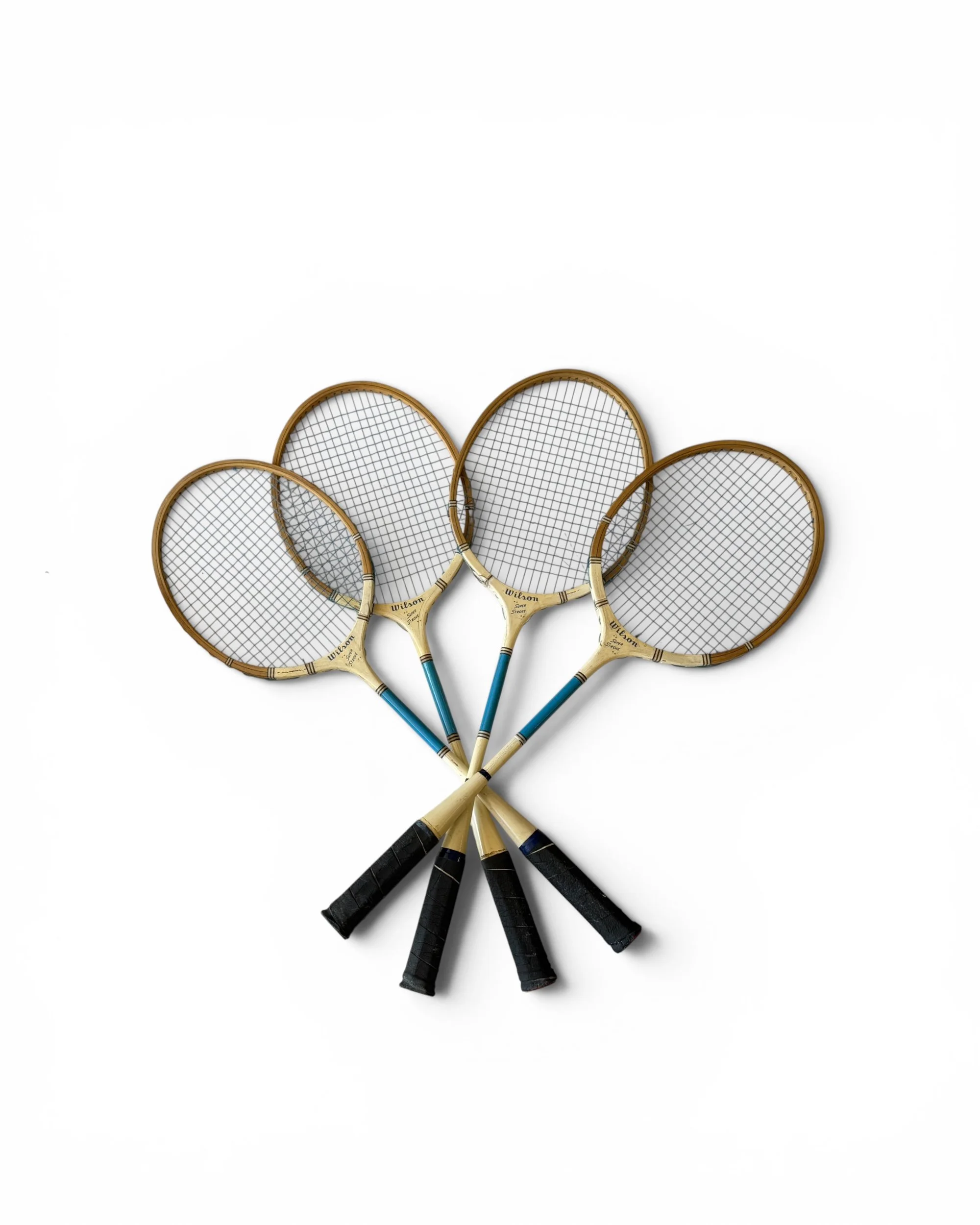 Four vintage badminton rackets arranged for gallery wall display.