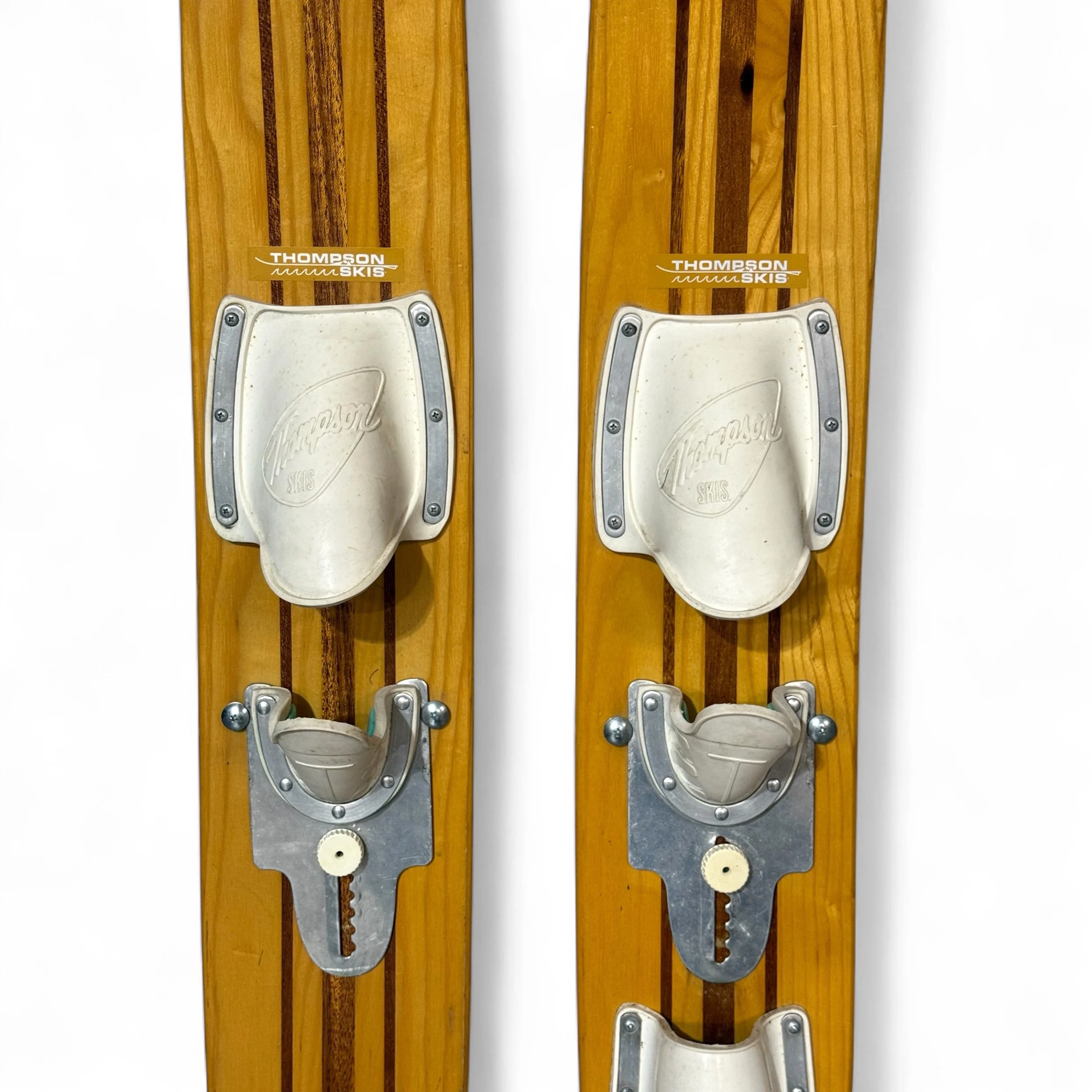 Close up view of the bindings on a pair of vintage Imperial wooden water skis made of mahogany and ash