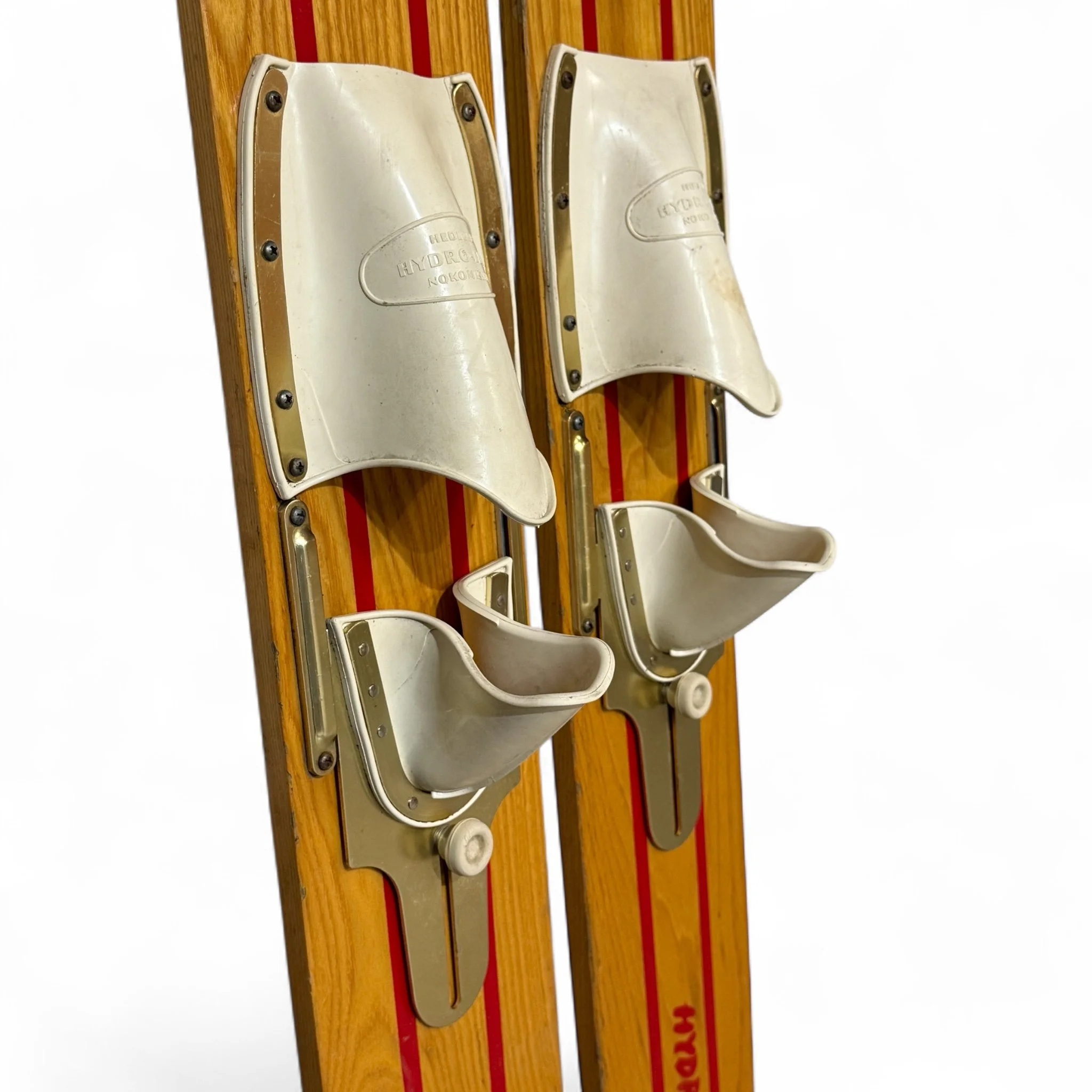 Close up view of bindings on vintage Hedlund Comet Hydro-Flite wooden water skis used as wall decor for lake house, beach house, or cabin.