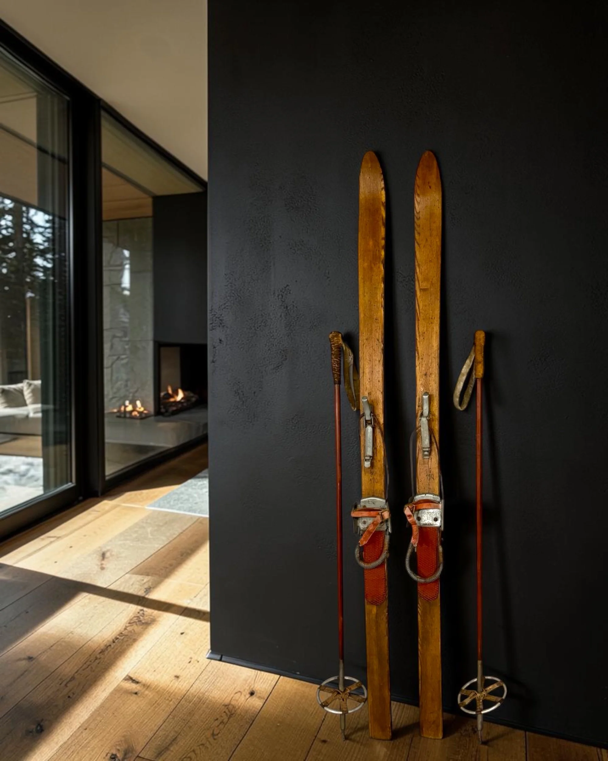 Rustic mountain lodge wall decor with vintage wooden snow skis and poles.