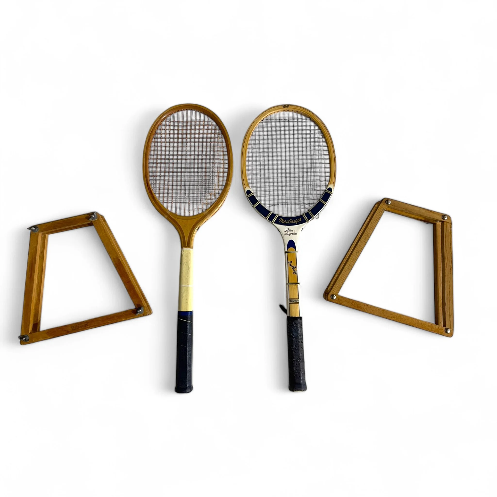 Pair of vintage wooden tennis rackets with wood presses, featuring the Wilson Super Stroke and the MacGregor Blue Supreme Lloyd Budge. Circa 1950s or 60s, perfect for game room decor.