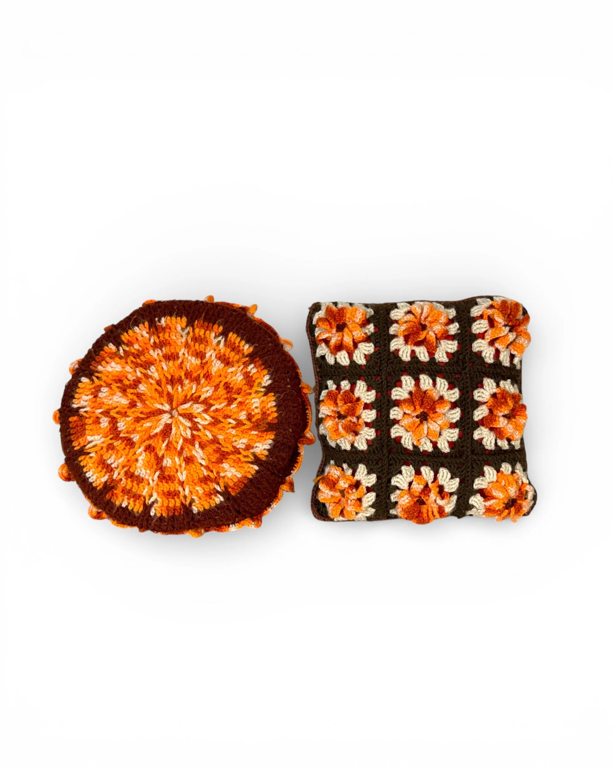 Set of two crochet accent pillows with round yarn pillow and square granny square pillow in fall colors