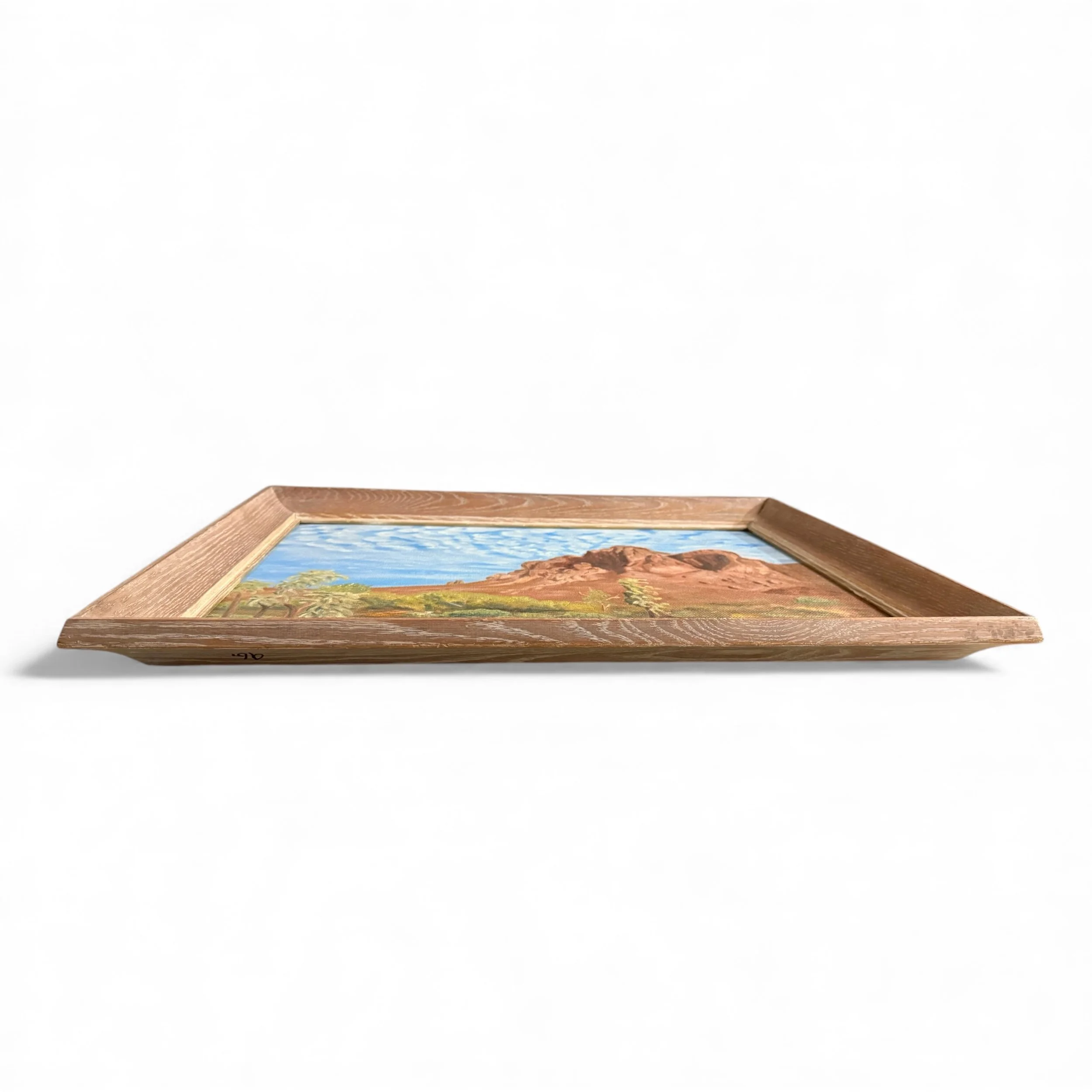 Side angle of framed vintage desert artwork
