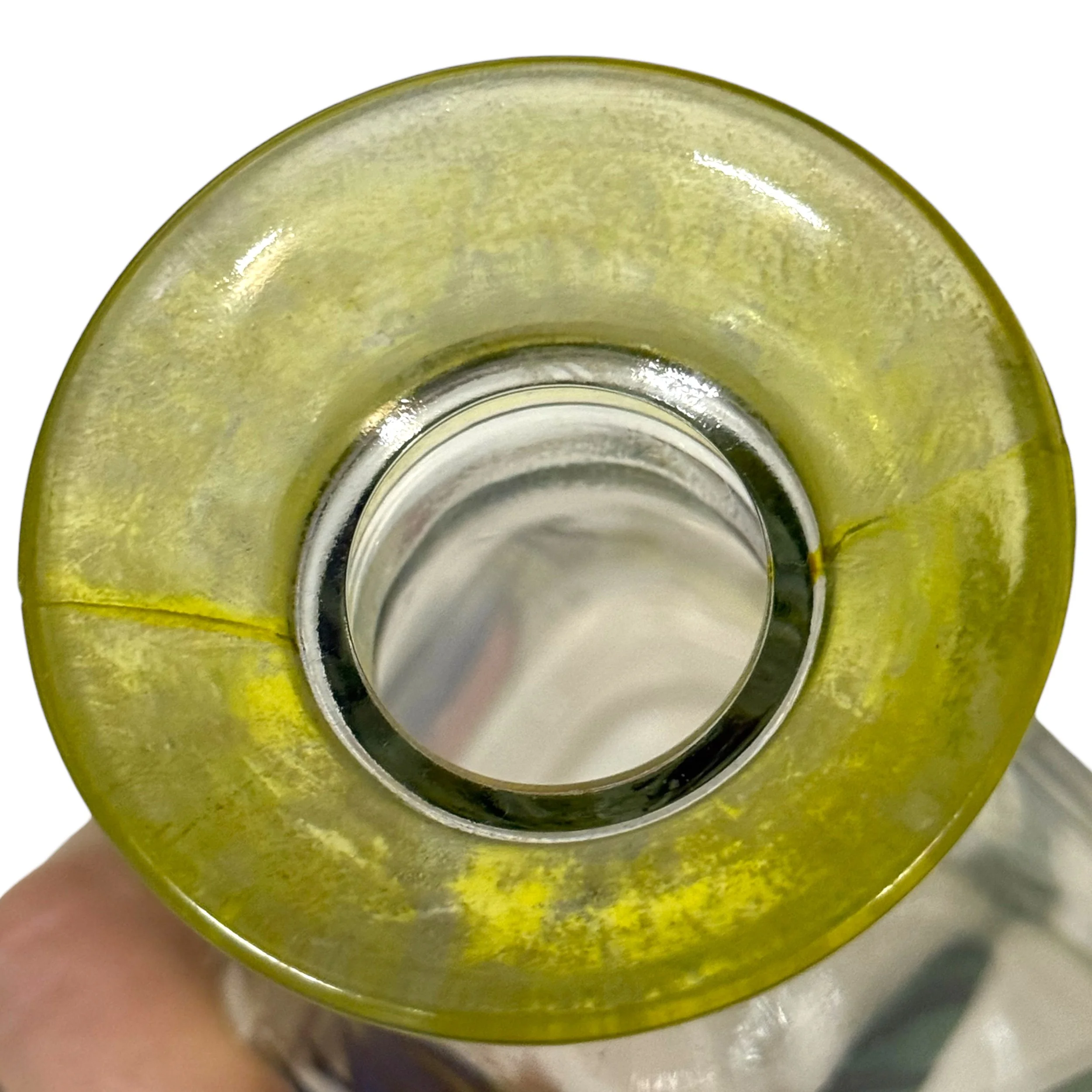 close up view of yellow round neck on vintage glass bottle