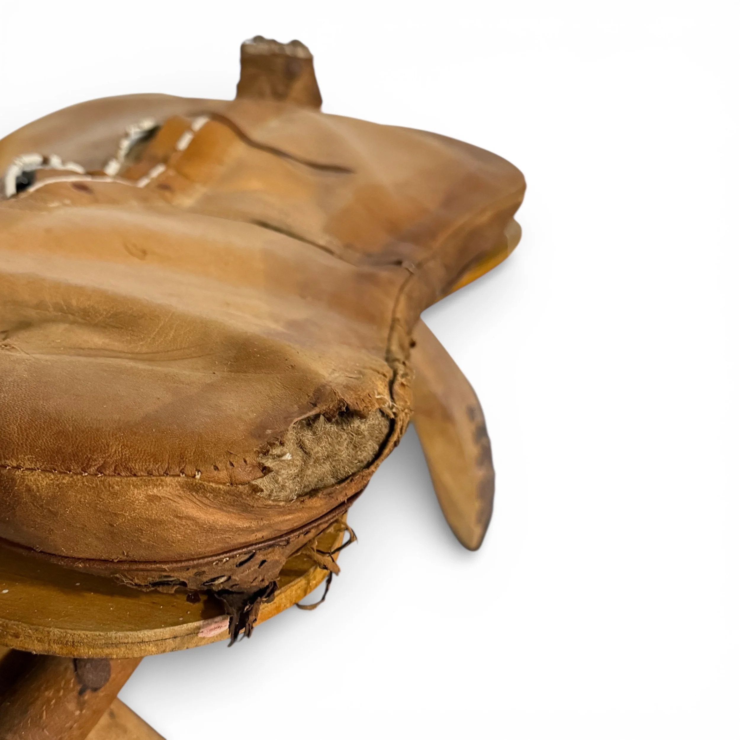 close up view of leather cushion on camel saddle showing extensive wear and patina