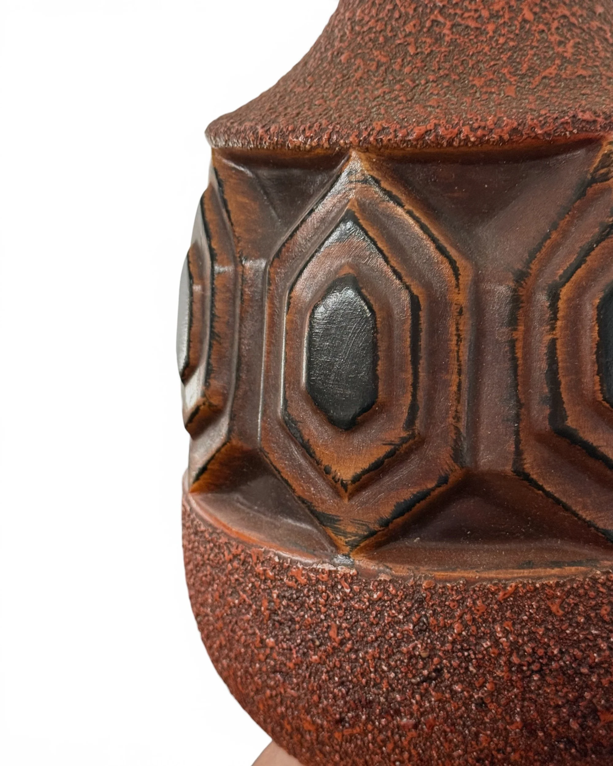 Close up of raised geometric ceramic pattern on vintage mid century lamp