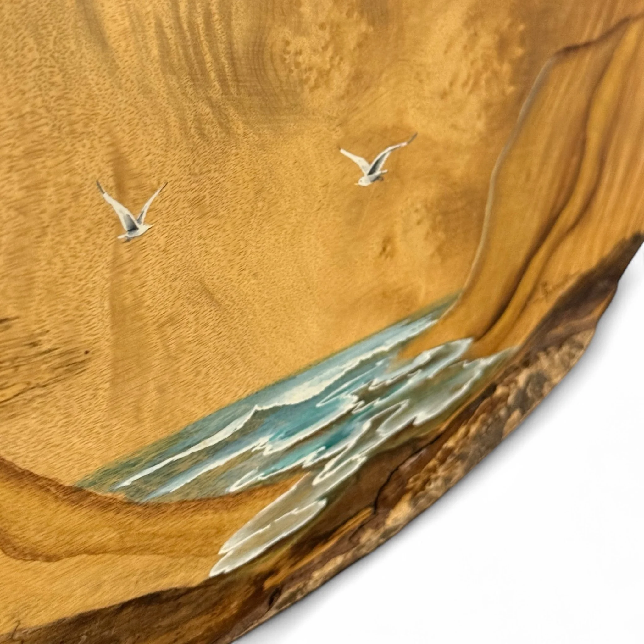 Close up view of live edge on a vintage Myrtlewood wall hanging with hand painted ocean scene that includes ocean, trees, and seagulls, rustic coastal home decor ready to hang.