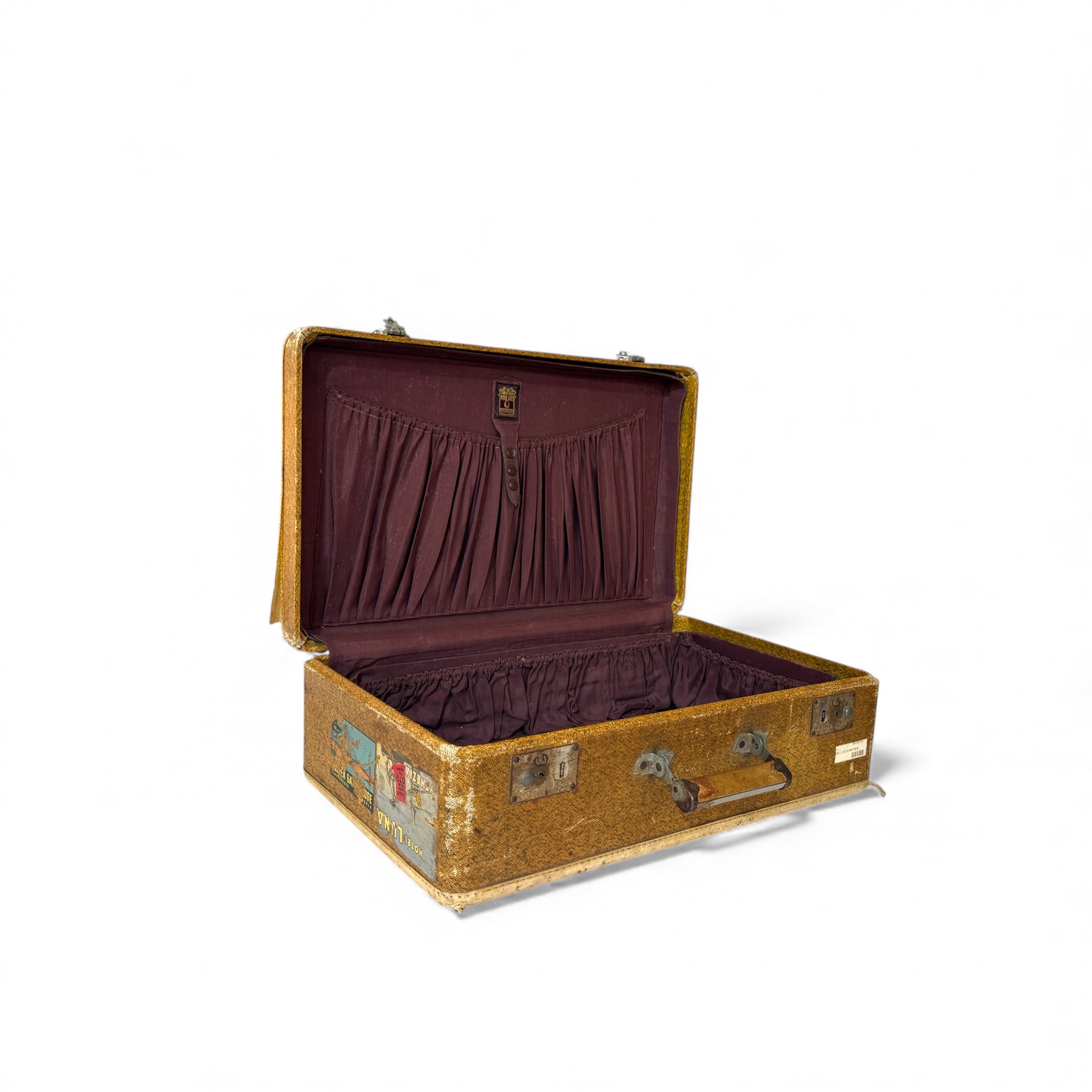 Side view of open antique suitcase with purple plum lining with gathered compartments