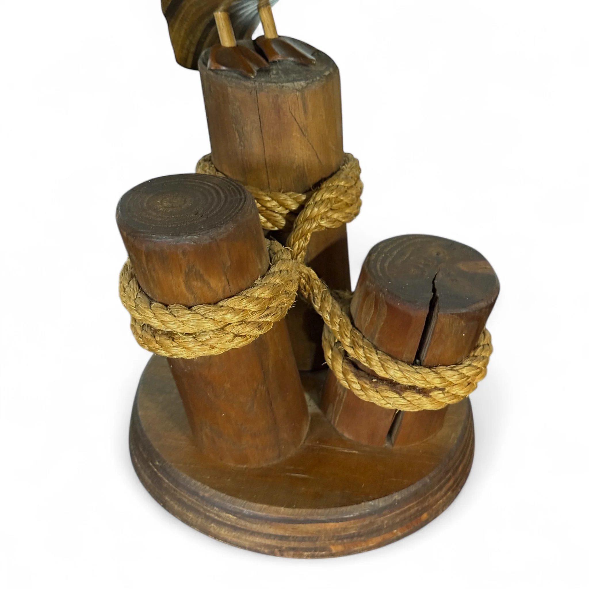 Close up view of 3 logs with rope used for coastal table or shelf decor