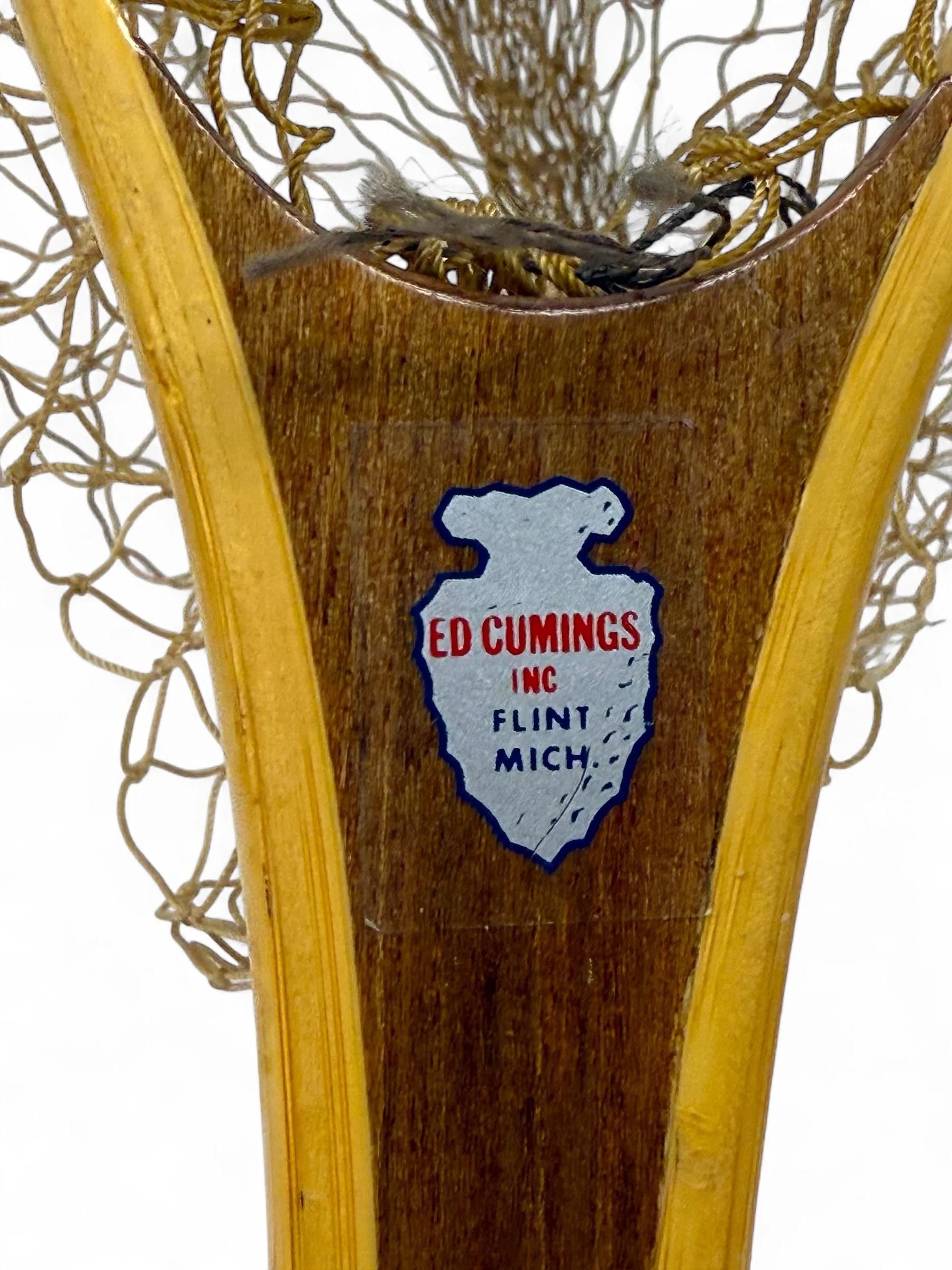 Close-up logo of a vintage Ed Cumings wooden fishing net handle and beige net detail