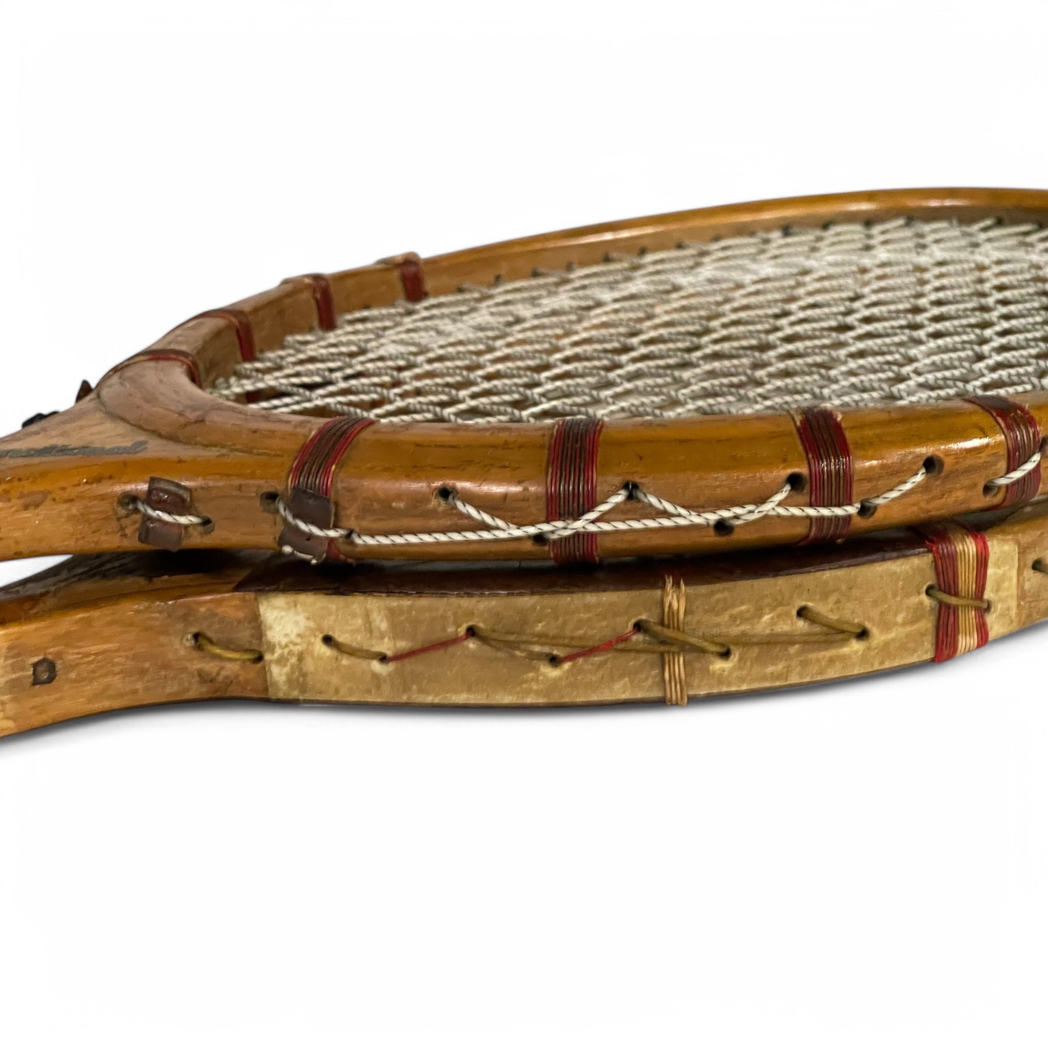Pair of vintage wooden tennis rackets from the 1920s-30s, perfect for antique sports decor and collectibles.