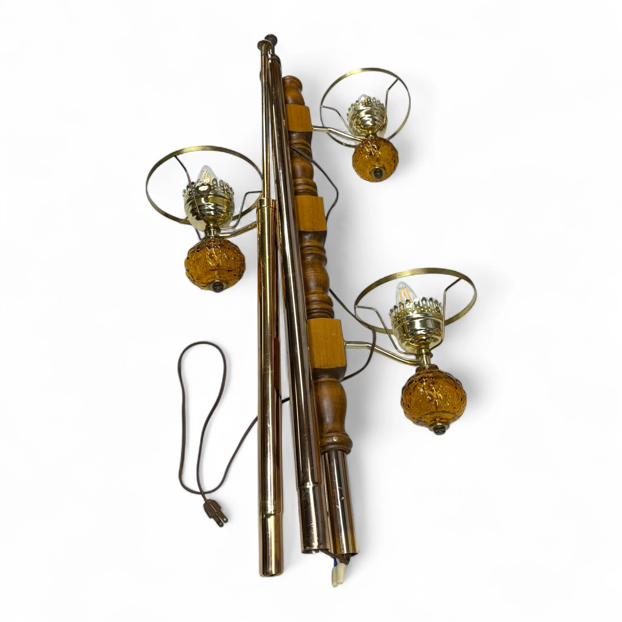 A vintage mid century modern tension pole floor lamp with 3 arms, amber quilted ruffle glass shades, wood and metal shown disassembled for transport.