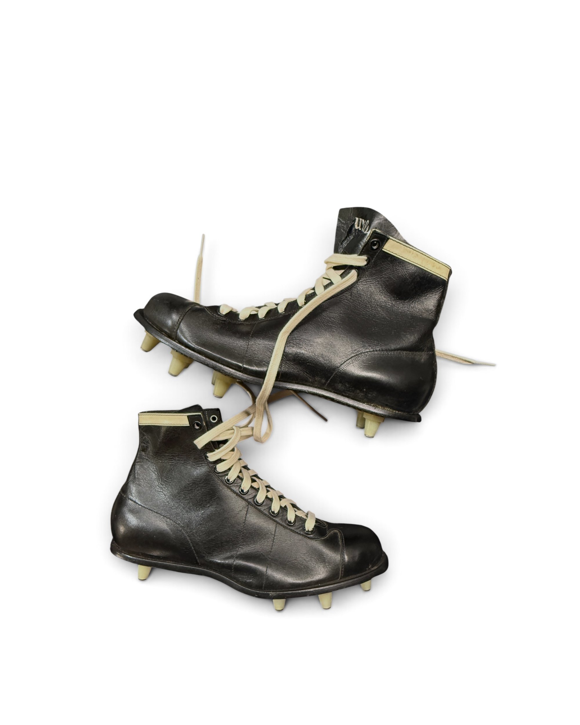 Wilson vintage football cleat showing black leather construction, cream laces and ankle trim
