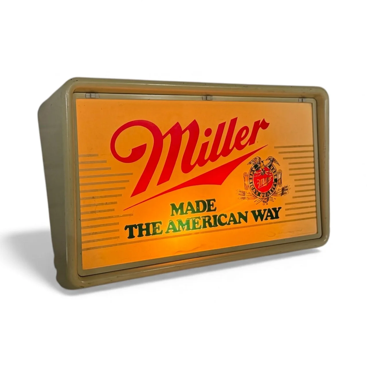 Side view vintage 1980s Miller “Made the American Way” lighted beer sign illuminated.