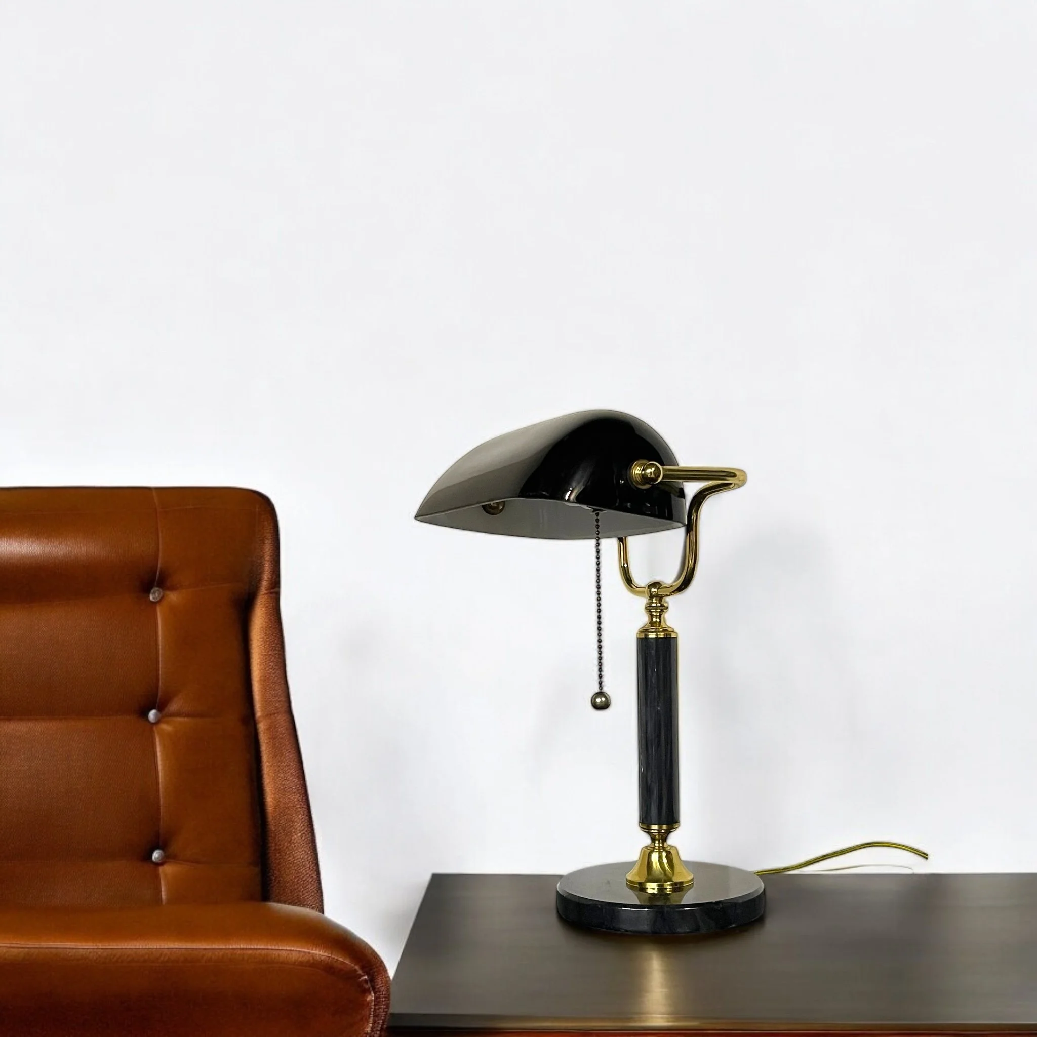Close up of a vintage bankers desk lamp featuring a sleek black glass shade, fully adjustable, round marble base, perfect for classic office lighting or Art Deco style decor.