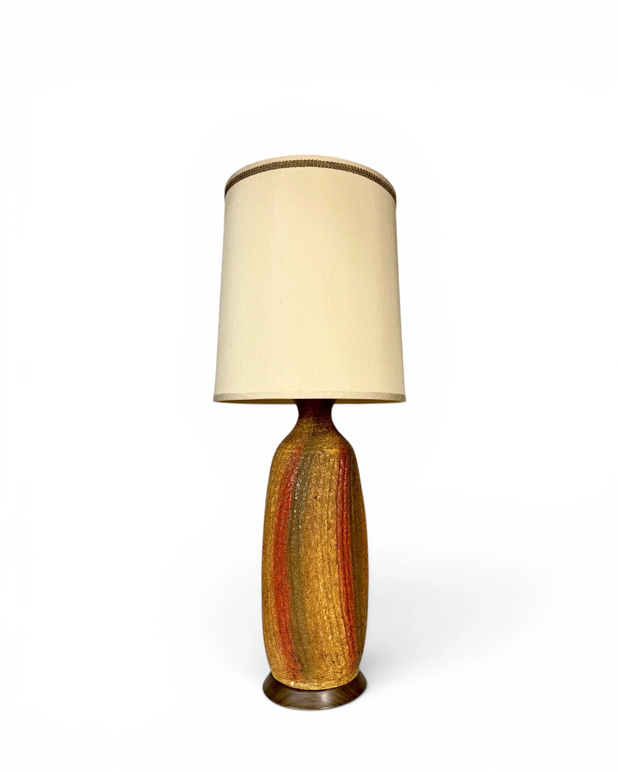 Vintage Quartite Creative Co. 1965 Mid Century Modern ceramic table lamp with textured gold volcanic glaze, burnt orange and olive green vertical accents, brass base, and cream drum shade.