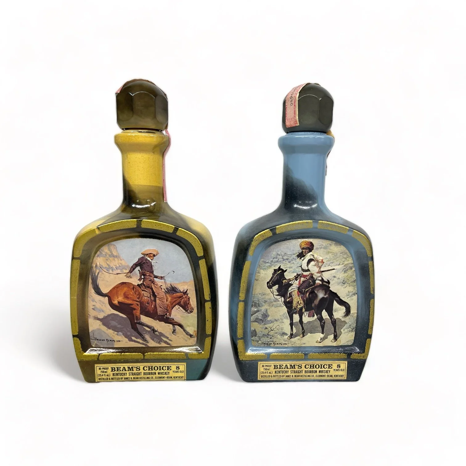 Vintage pair of glass 1970s Jim Beam Choice liquor bottles, featuring the cowboy and the Indian trapper. Perfect home bar decor.