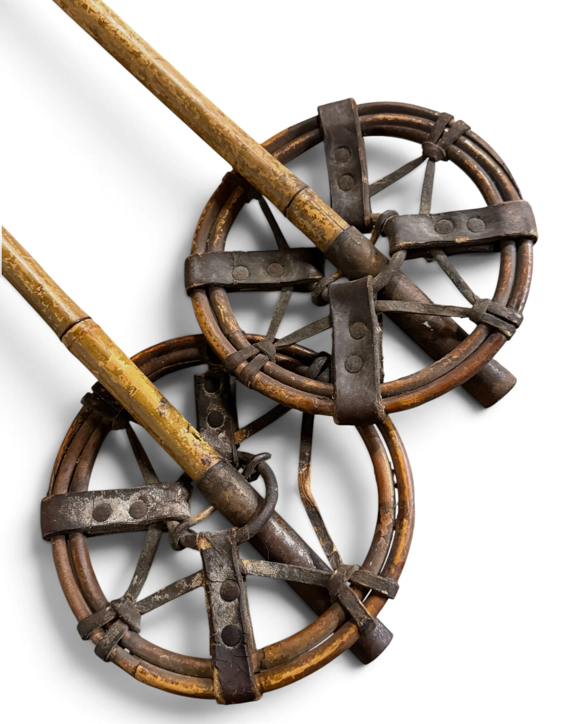 close up view of leather baskets on antique bamboo ski poles