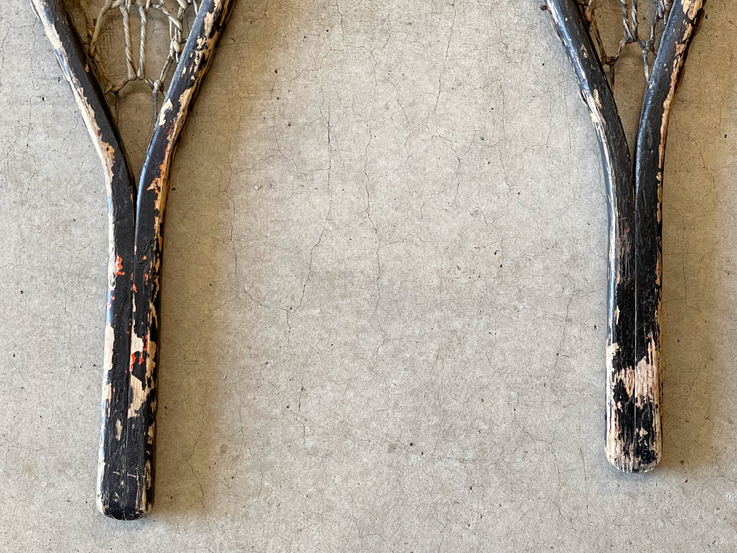 Vintage pair C.A. Lund Wooden Snowshoes with leather bindings.