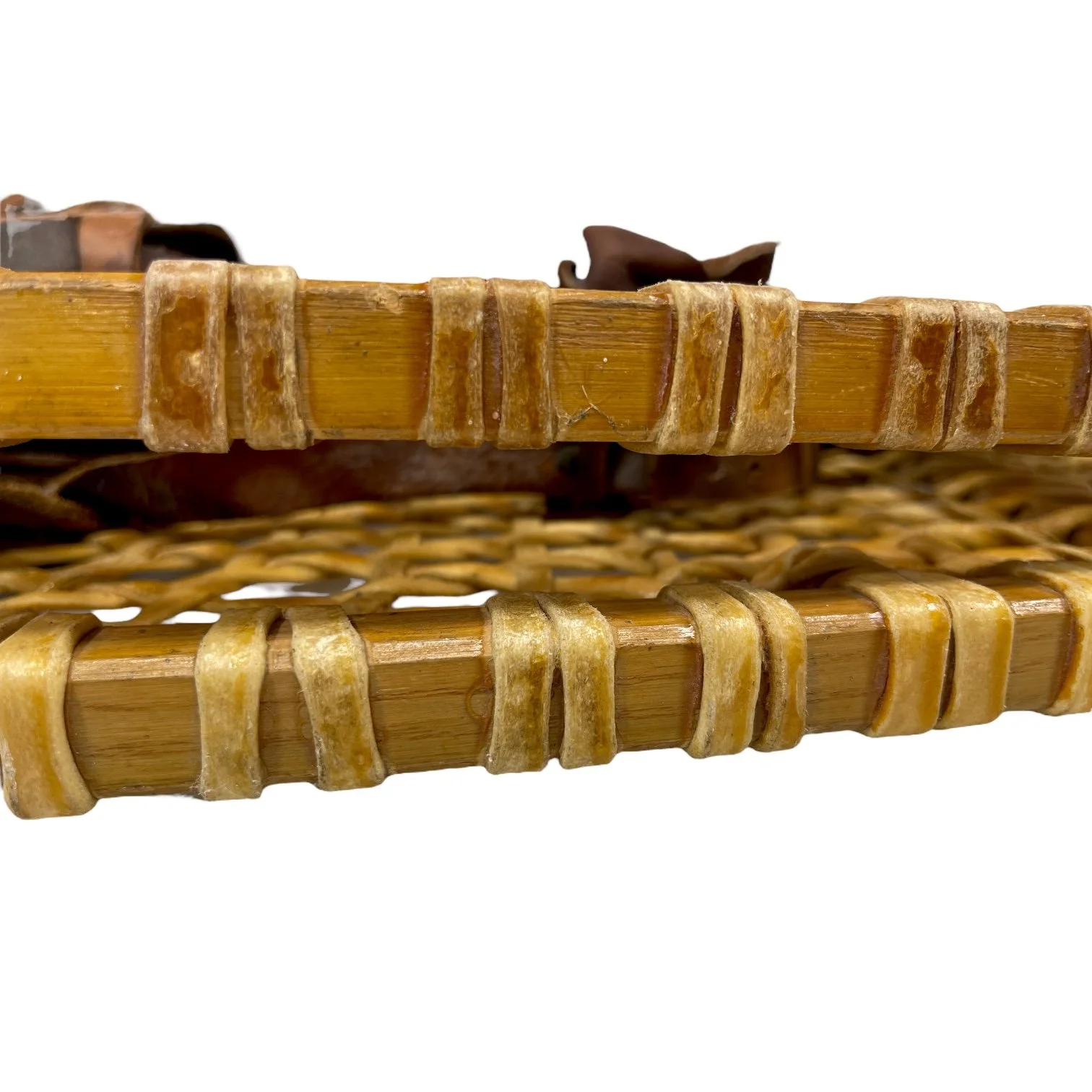 Pair of vintage wooden snowshoes with ski poles made of bamboo and cork - classic rustic winter gear perfect for cabin decor, lodge style, or outdoor adventures.