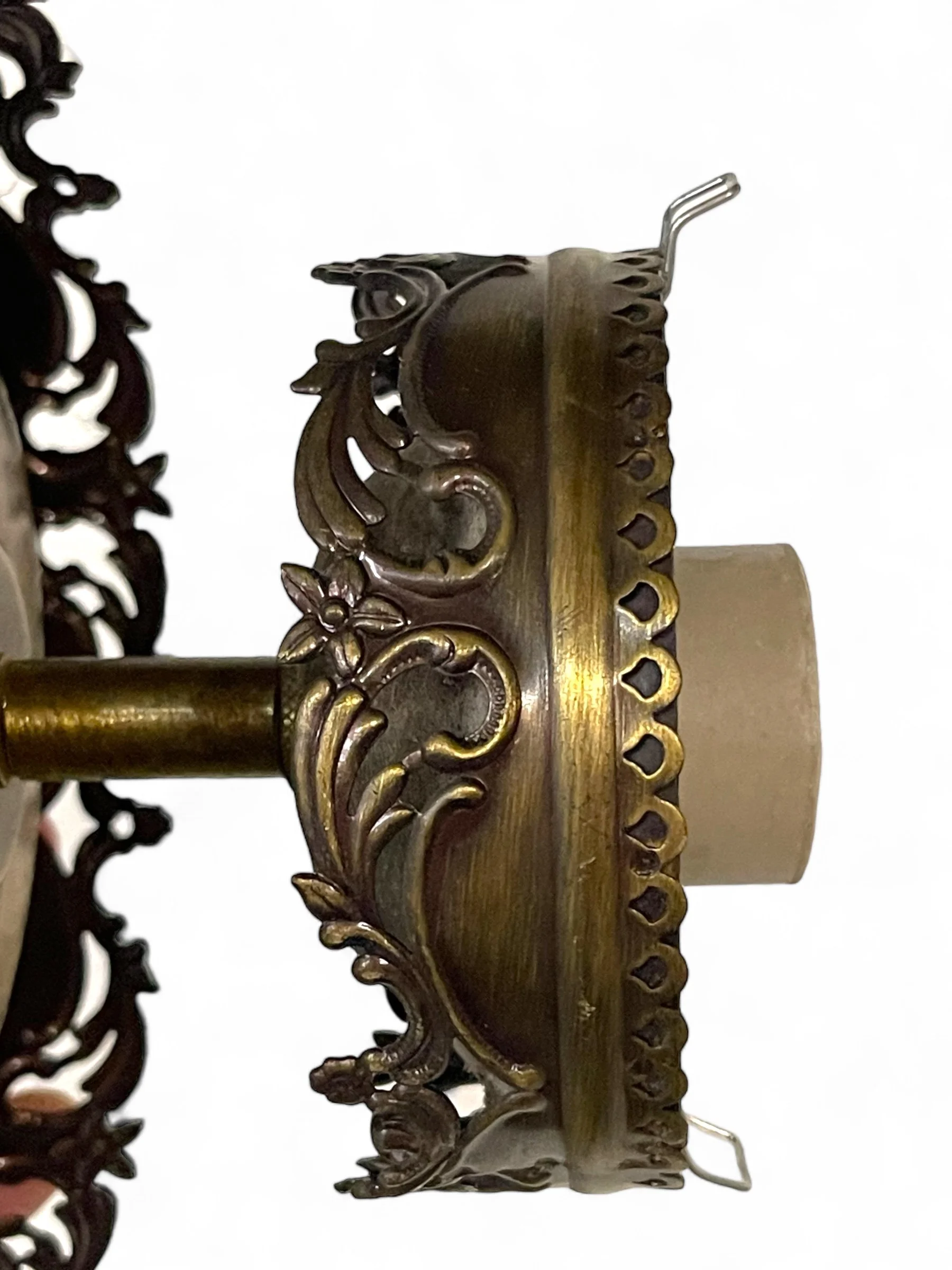 A vintage bathroom light fixture, hardwired ceiling mount, featuring ornate Victorian style cut gold metal with etched glass globe, 9 1/2 inches long.