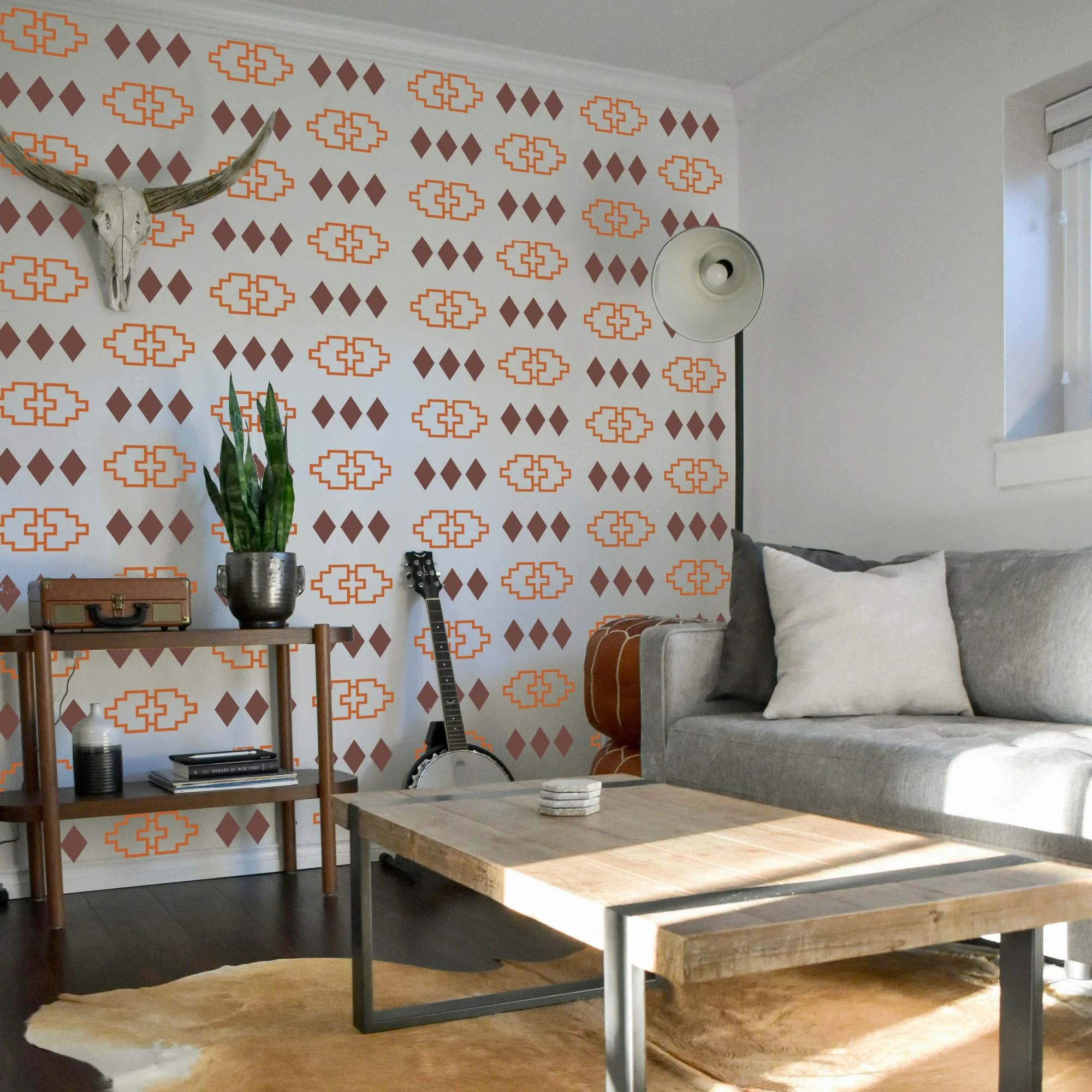 Living room with removable vinyl wall decals in Western Navajo geometric design, featuring nut brown and brown patterns. Boho Southwestern themed decor.
