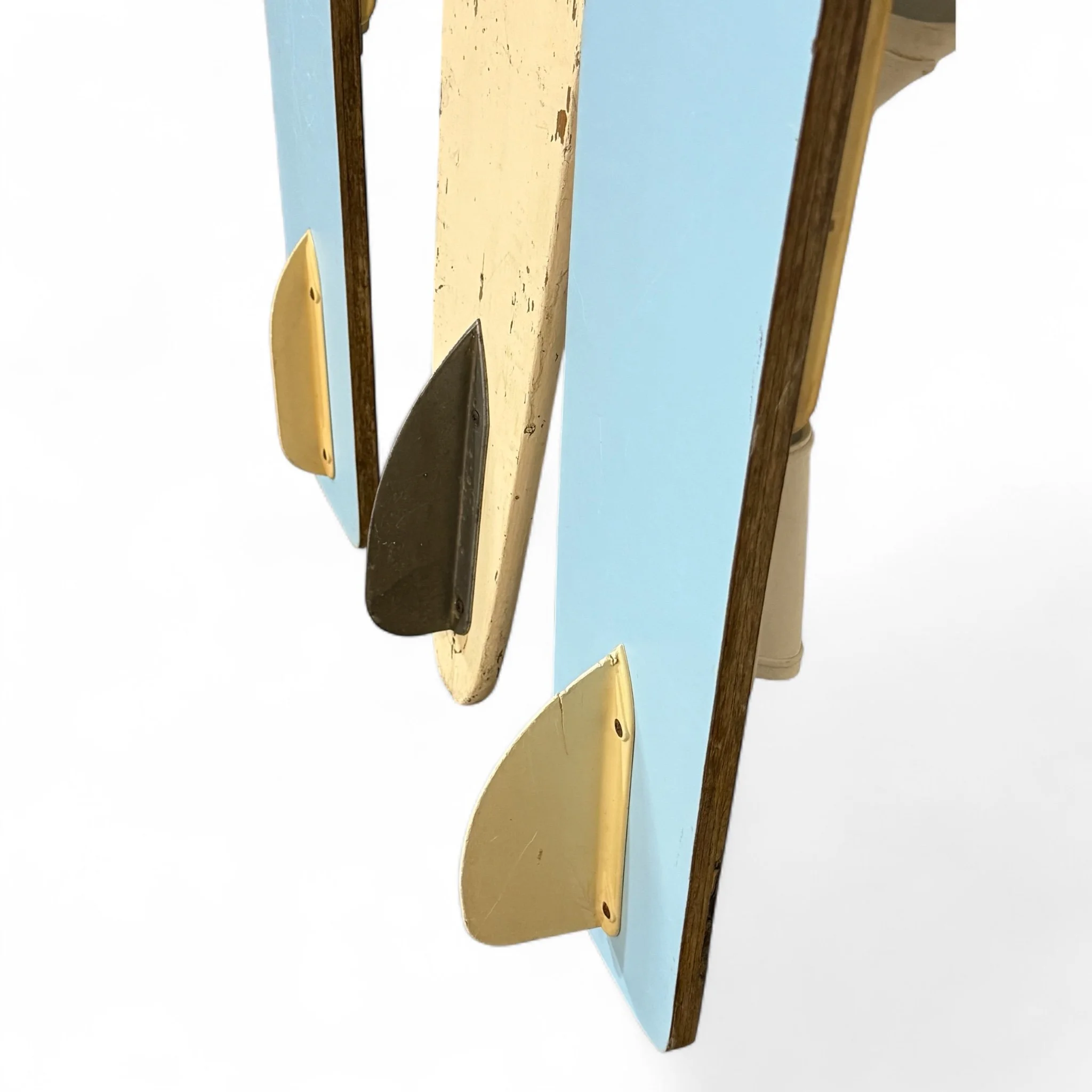 Close up view of fins on a set of 3 vintage kids wooden water skis, powder blue and white, perfect for nautical or coastal themed interiors.