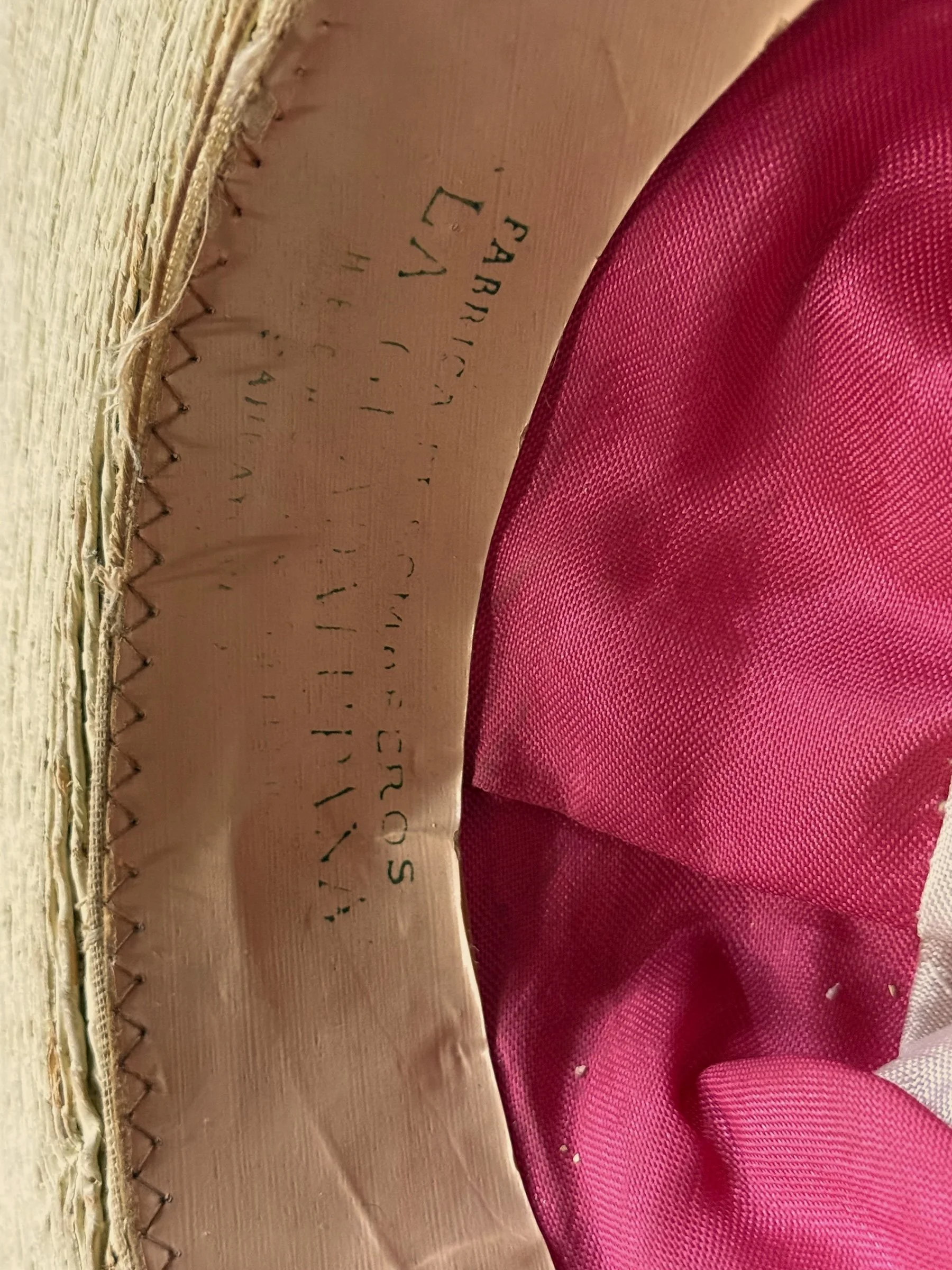 Inside of a vintage Mexican sombrero with a label that reads Fabrica de Sombreros La Guadalupana Hecho en Mexico Sahuayo Mich