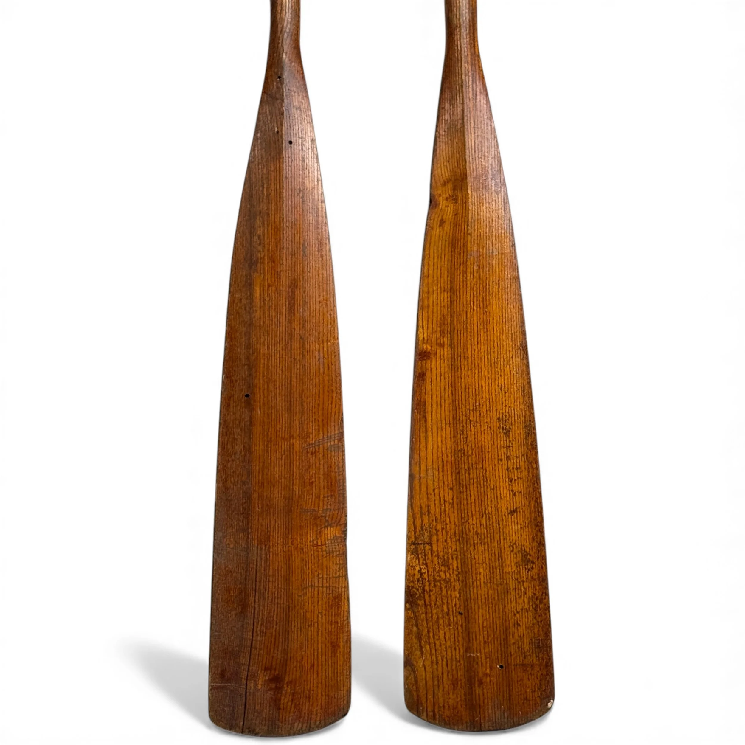 Close up of paddles on a pair of vintage wood boat oars showing the natural wood grain