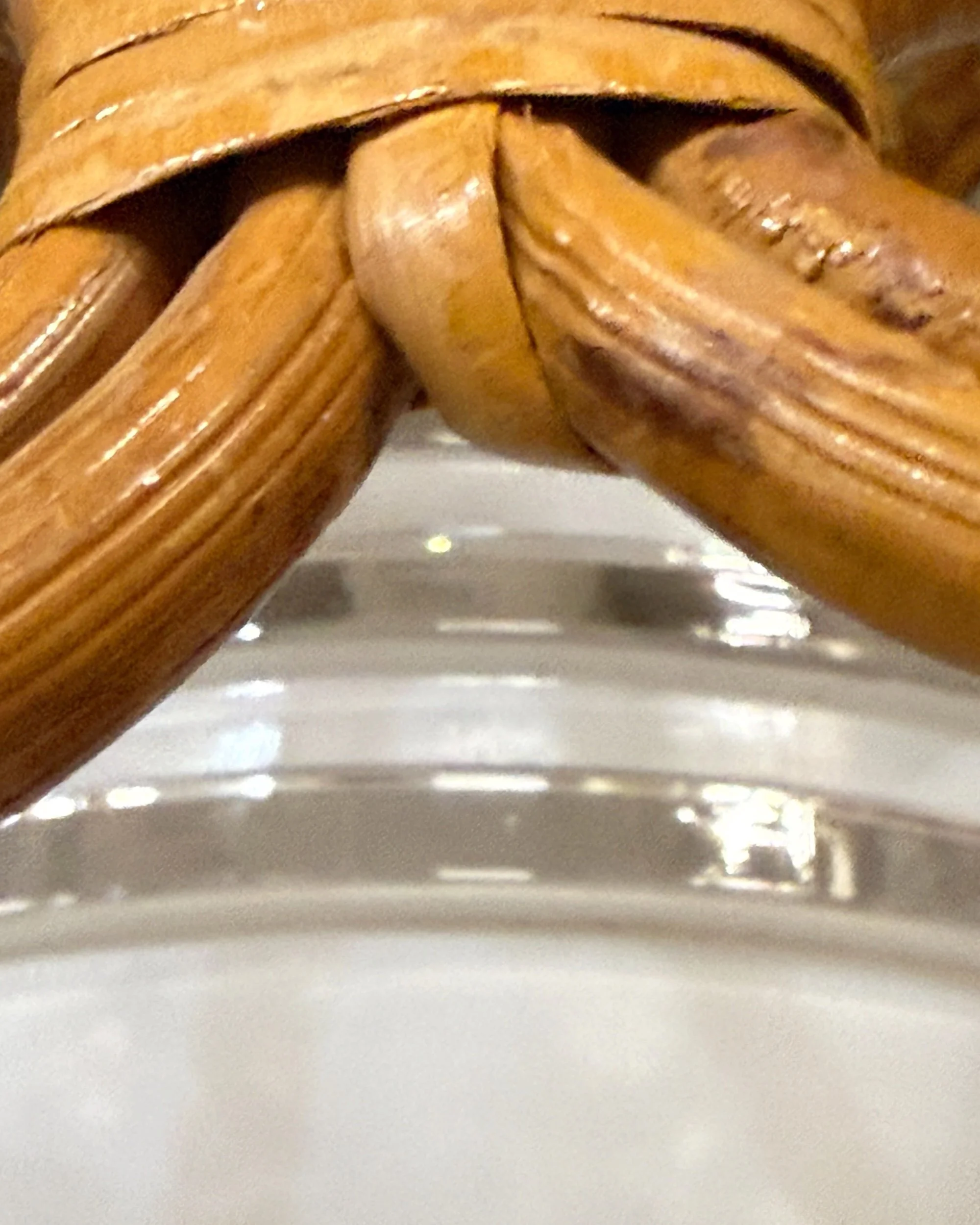 close up view of vintage white glass globe that has 3 bands of clear glass around the circumference