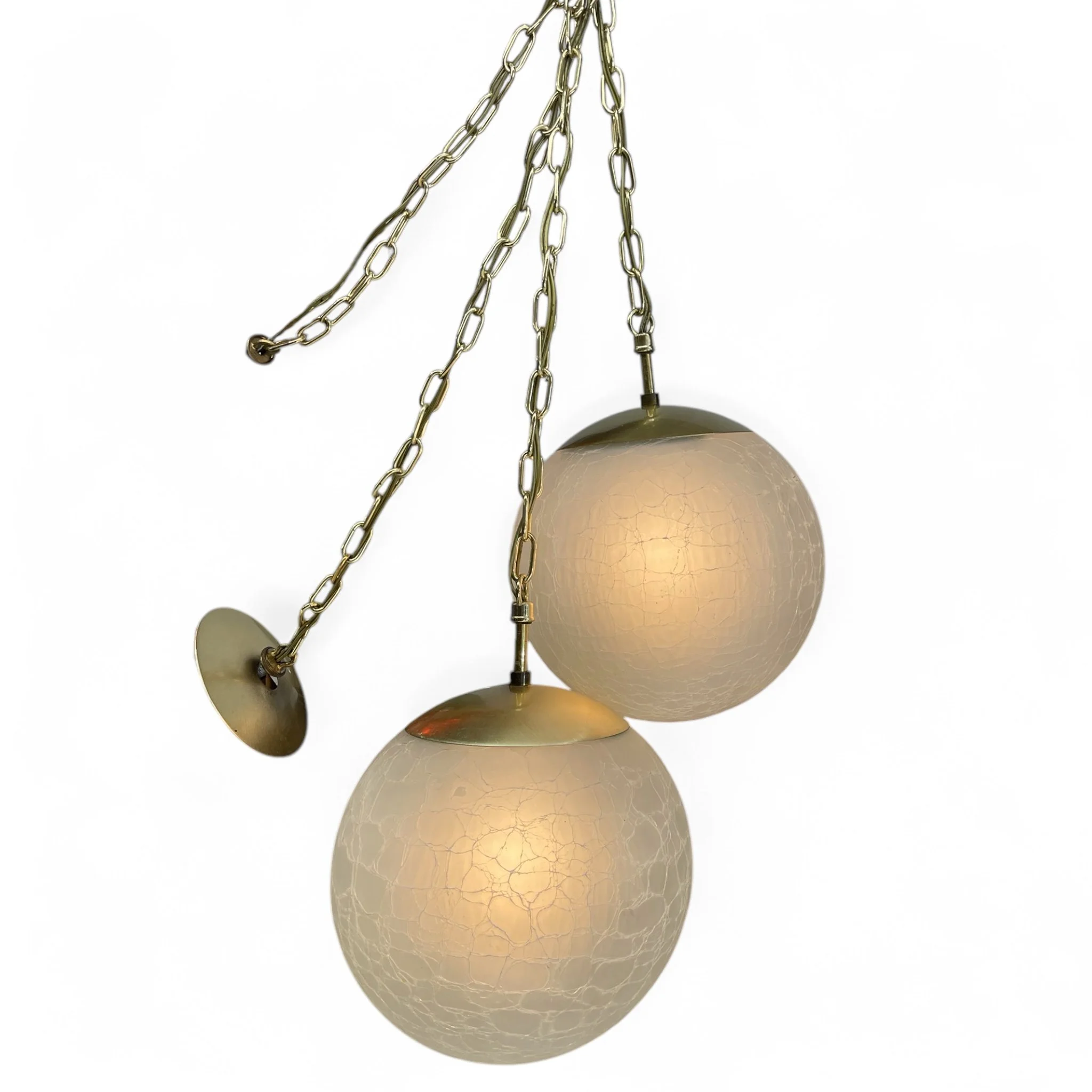Pair of large vintage frosted crackle glass orb pendant swag hanging lights with gold chain and finial, mid century modern design, perfect for vintage home decor or retro interior lighting.