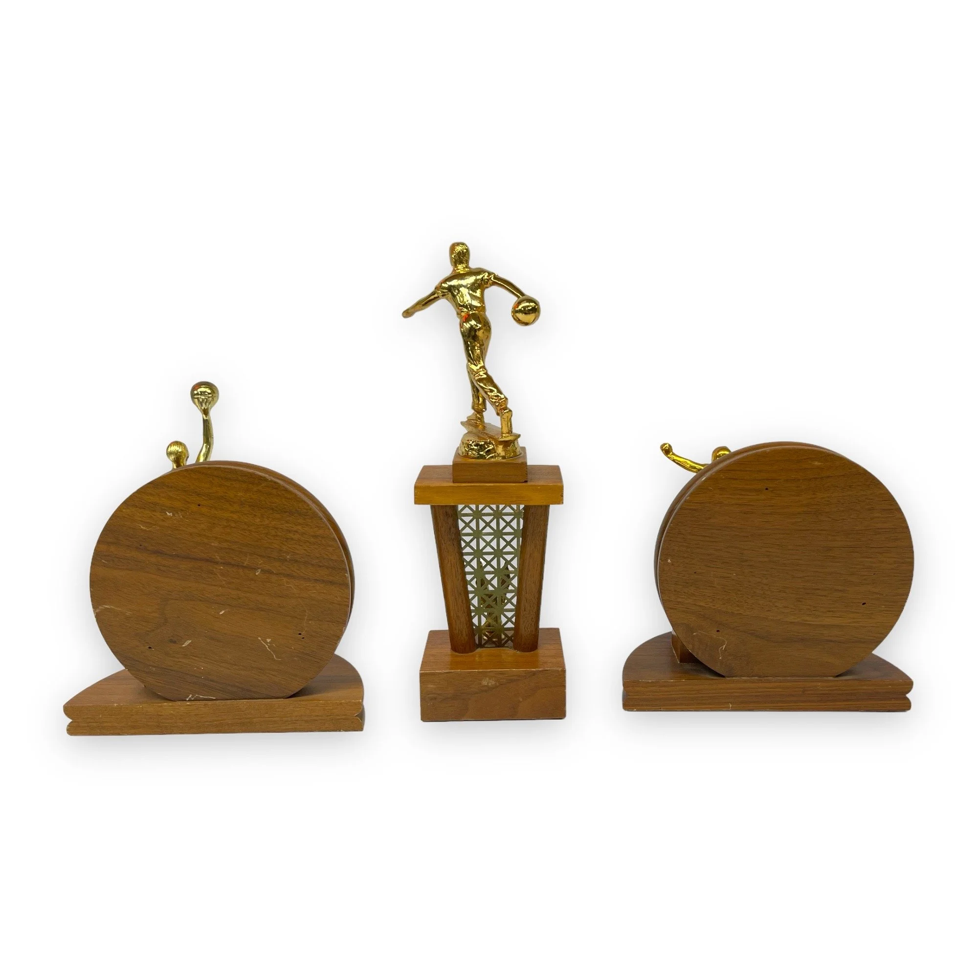 Vintage set of 3 trophies in mid century modern designs. Trophies are from the 50s and 60s and are made of wood with gold metal engraved plates.