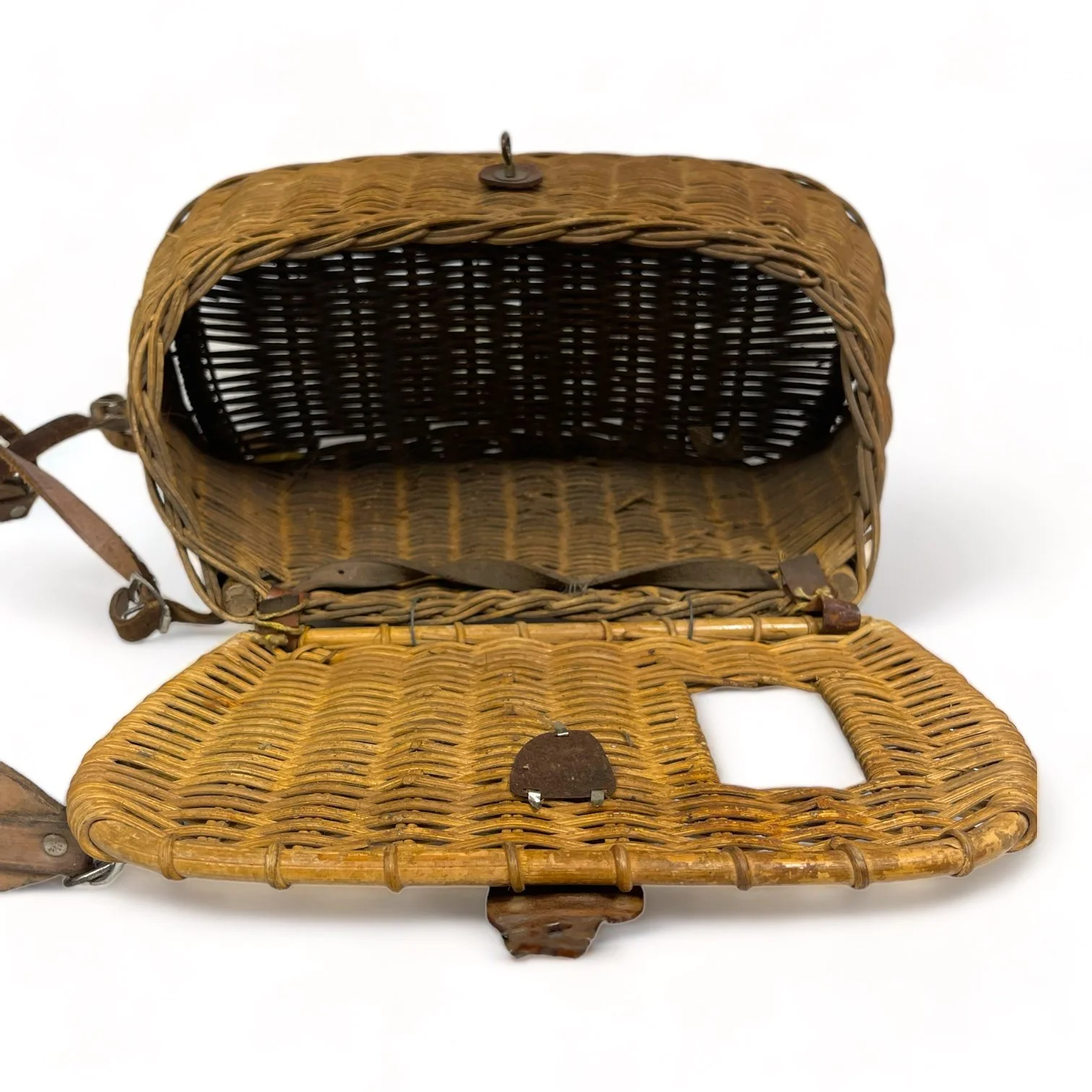 Vintage wicker fishing creel with adjustable leather shoulder strap and leather and metal lid clasp shaped as a fish. Great rustic decor for cabin or lodge.