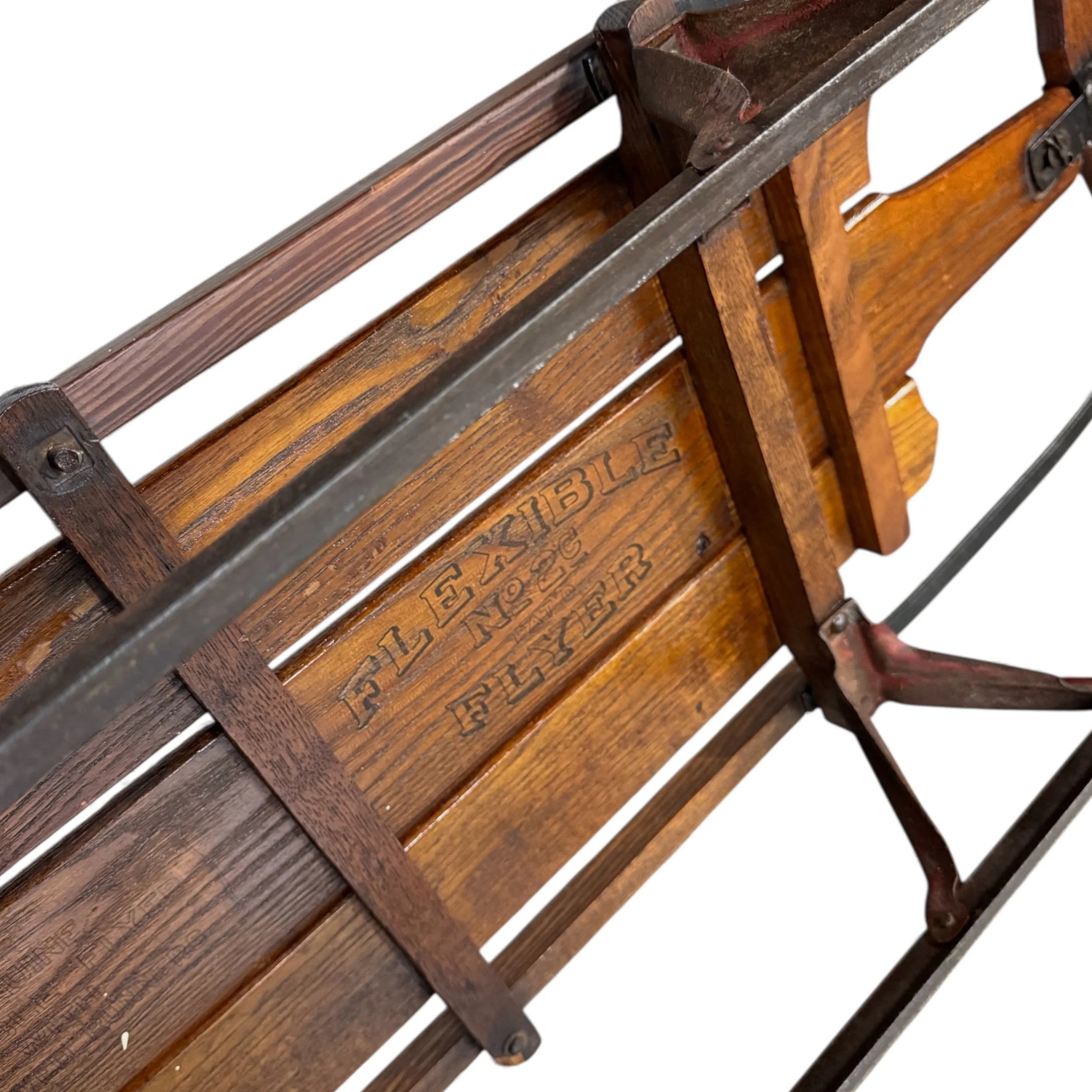 Close up of underside wooden sled that reads Flexible Flyer No 2C