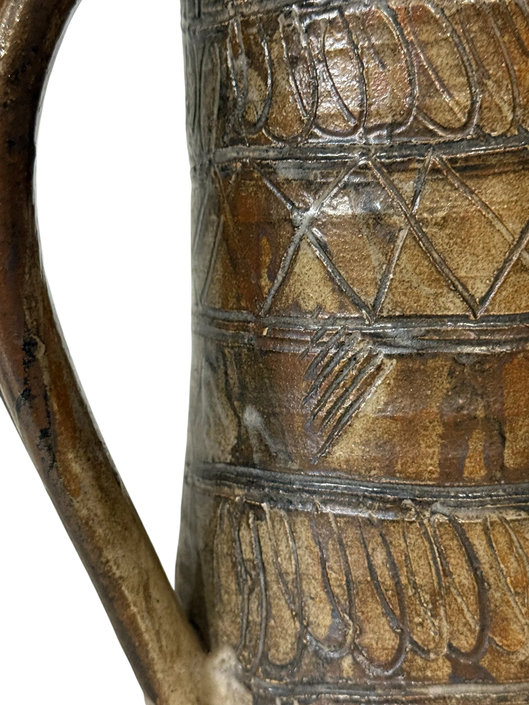 Close-up detail of etched geometric patterns on vintage pottery