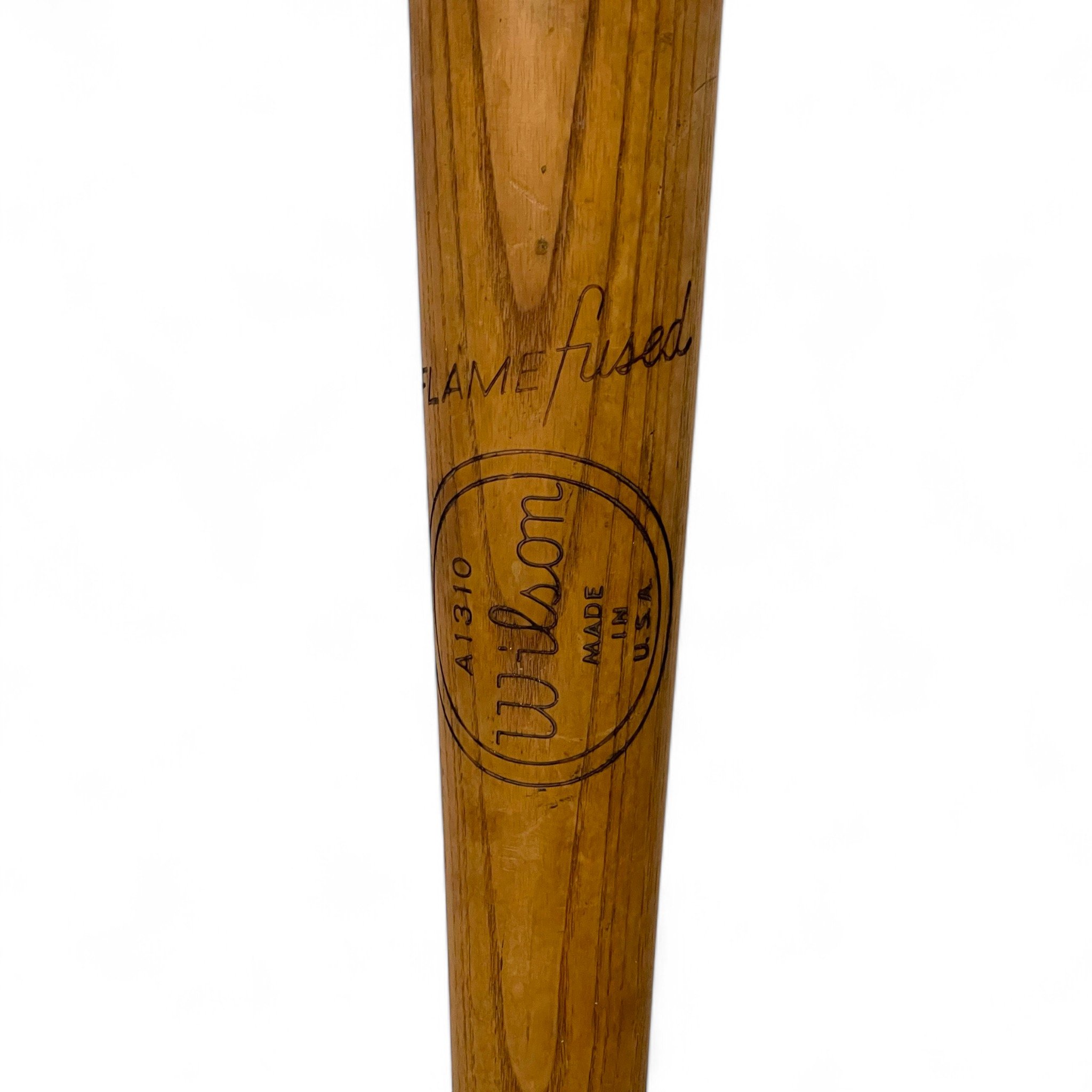 Close up of a vintage Wilson A1310 flamed fused wooden baseball bat, Nelson Fox Famous Players Special, paired with a classic vintage baseball, authentic sports memorabilia and collectibles.