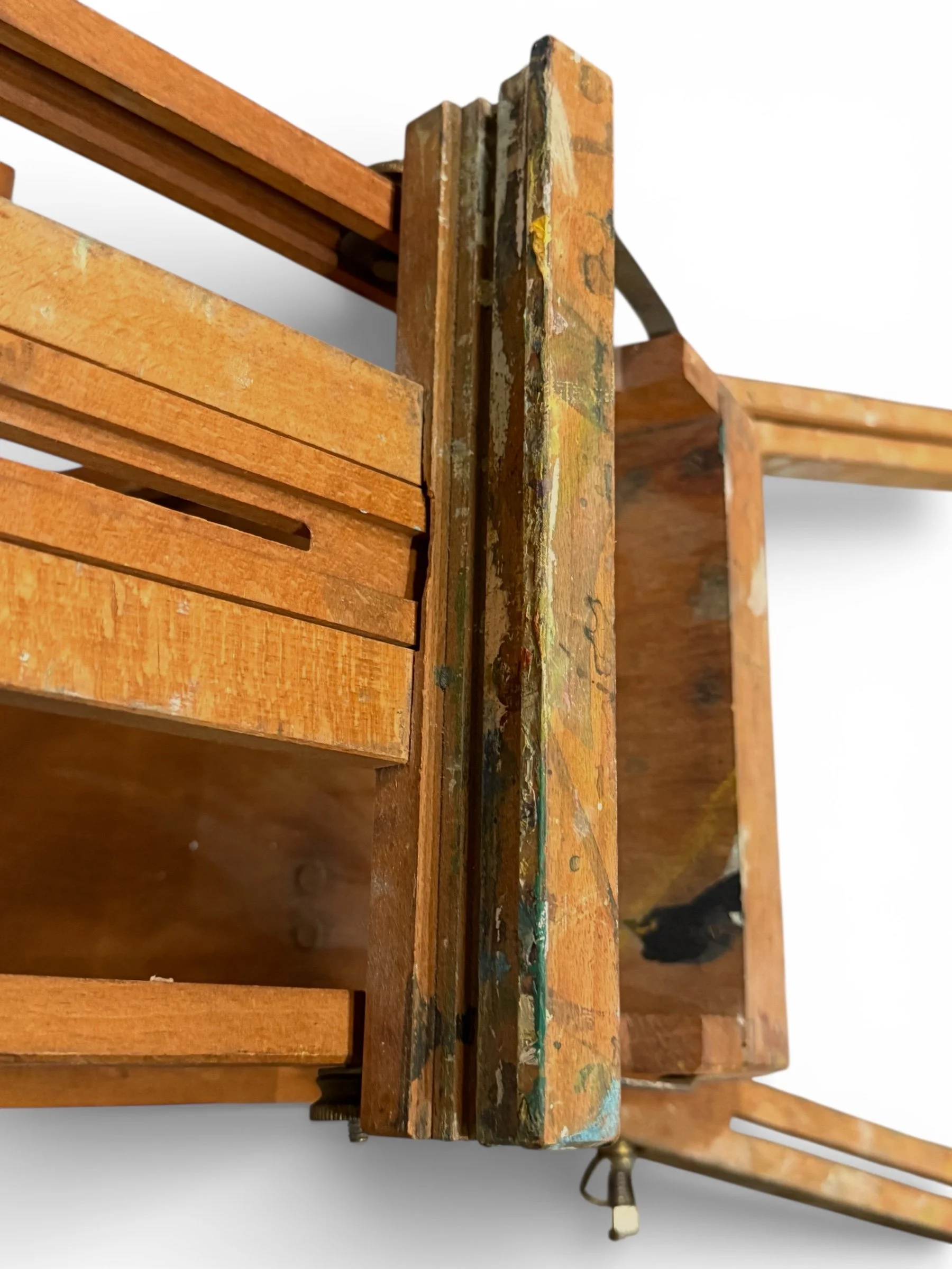 close up view of tray with dried paint on a vintage wooden French easel
