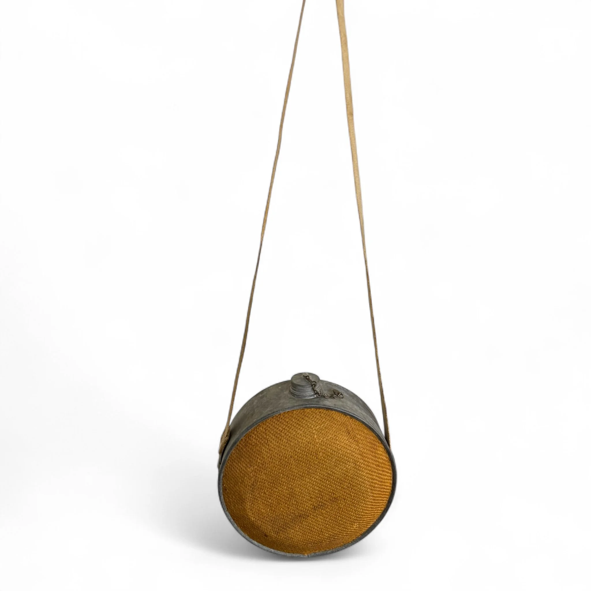 Vintage burlap and galvanized metal canteen with adjustable canvas strap, for rustic decor use in a cabin, lodge, or western inspired space.