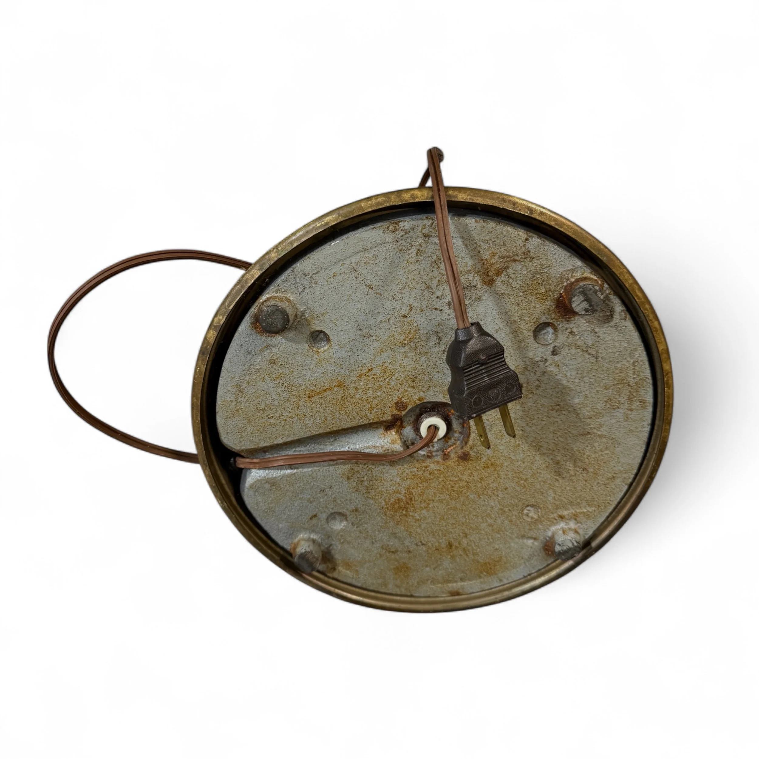 Vintage brass floor lamp on its side showing the bottom weighted base and cord