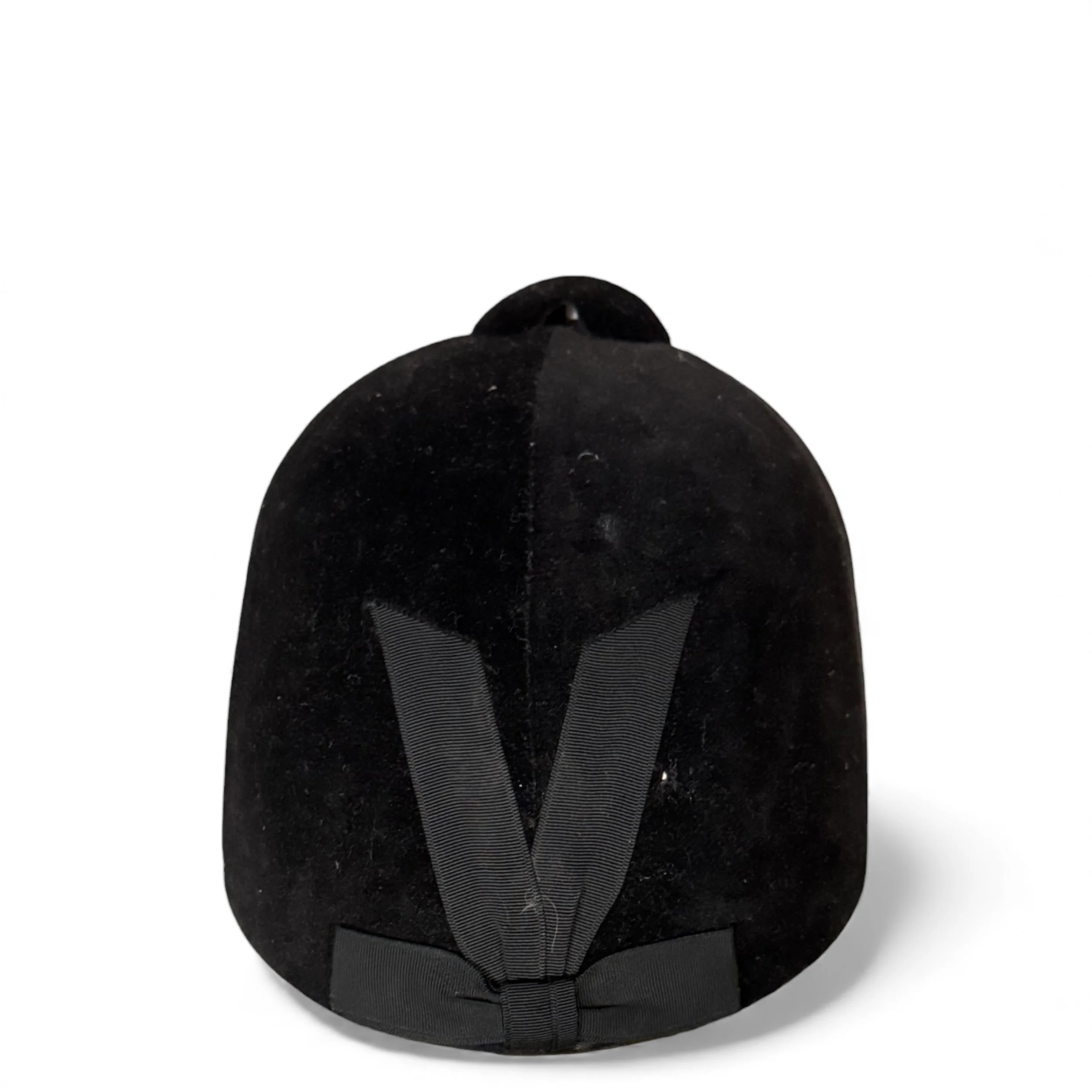 Close-up of grosgrain ribbon detailing on back of equestrian riding helmet.