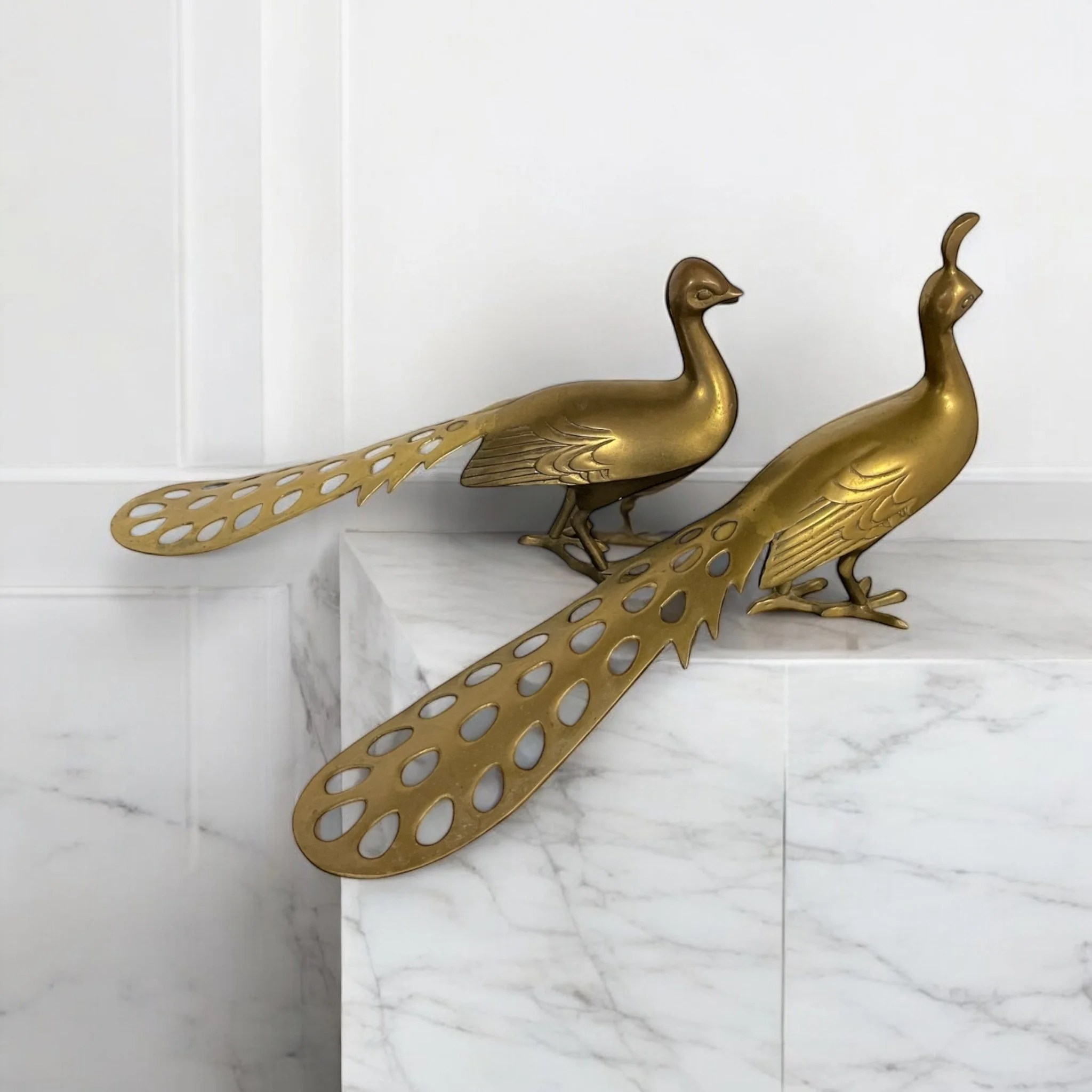 A pair of large vintage brass peacocks, male and female each 20 inches long suitable for living room tabletop or bedroom dresser decor.