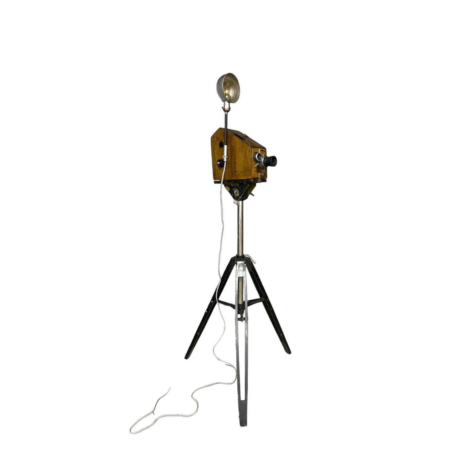 An antique United States Cam-O-Corp, Cam-O #1096 wooden camera mounted on an adjustable wood and steel black tripod. Made in USA.