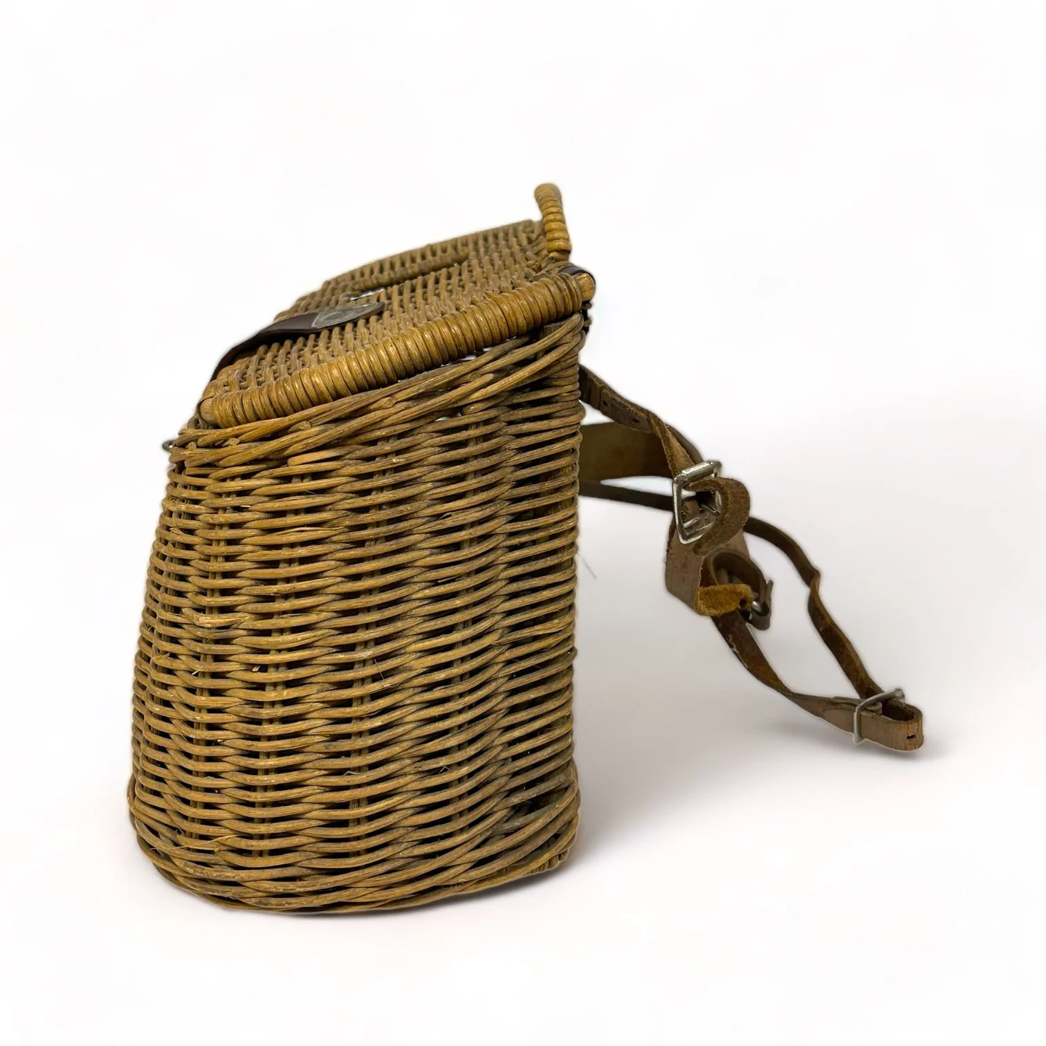 Vintage wicker fishing creel with adjustable leather shoulder strap and leather and metal lid clasp shaped as a fish. Great rustic decor for cabin or lodge.